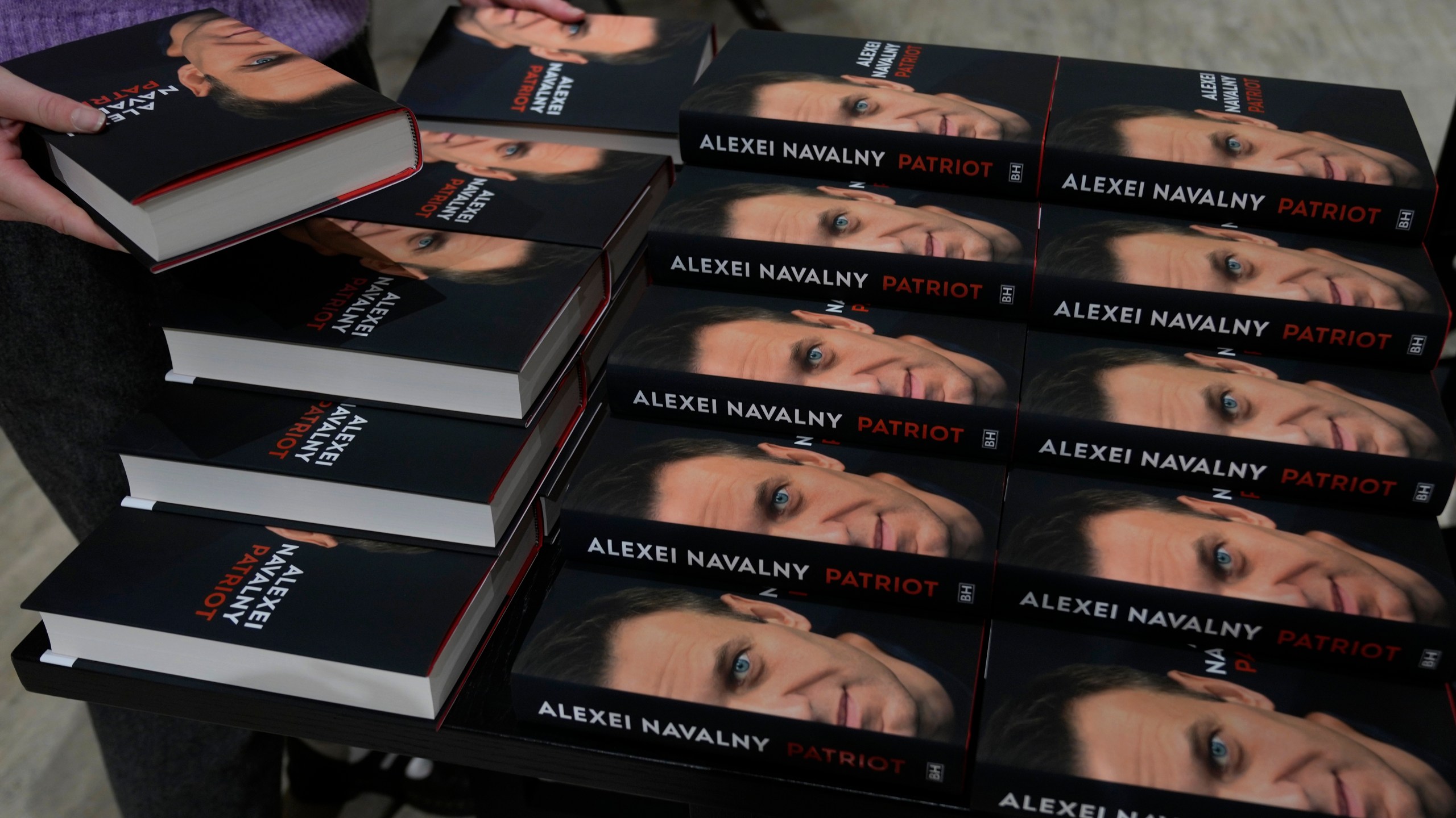 Copies of the late Russian opposition leader Alexei Navalny's memoir entitled 'Patriot' are put display on the first day of sale in a bookshop in London, Tuesday, Oct. 22, 2024. (AP Photo/Alastair Grant)