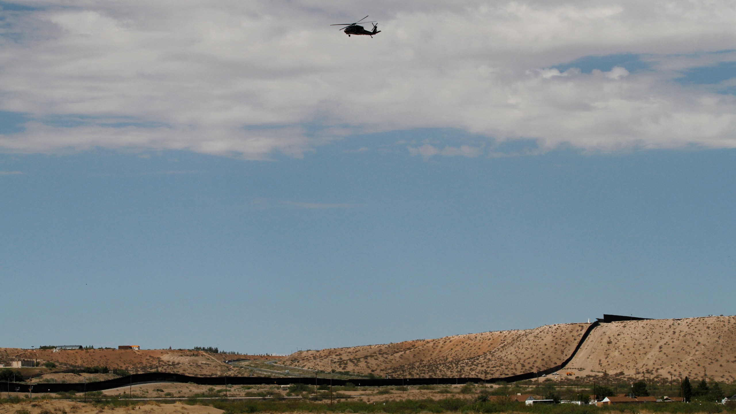 A surveillance helicopter traces a line in the sky above the Southwest border with Mexico at Sunland Park, N.M., Thursday, Aug. 22, 2024. (AP Photo/Morgan Lee, File)