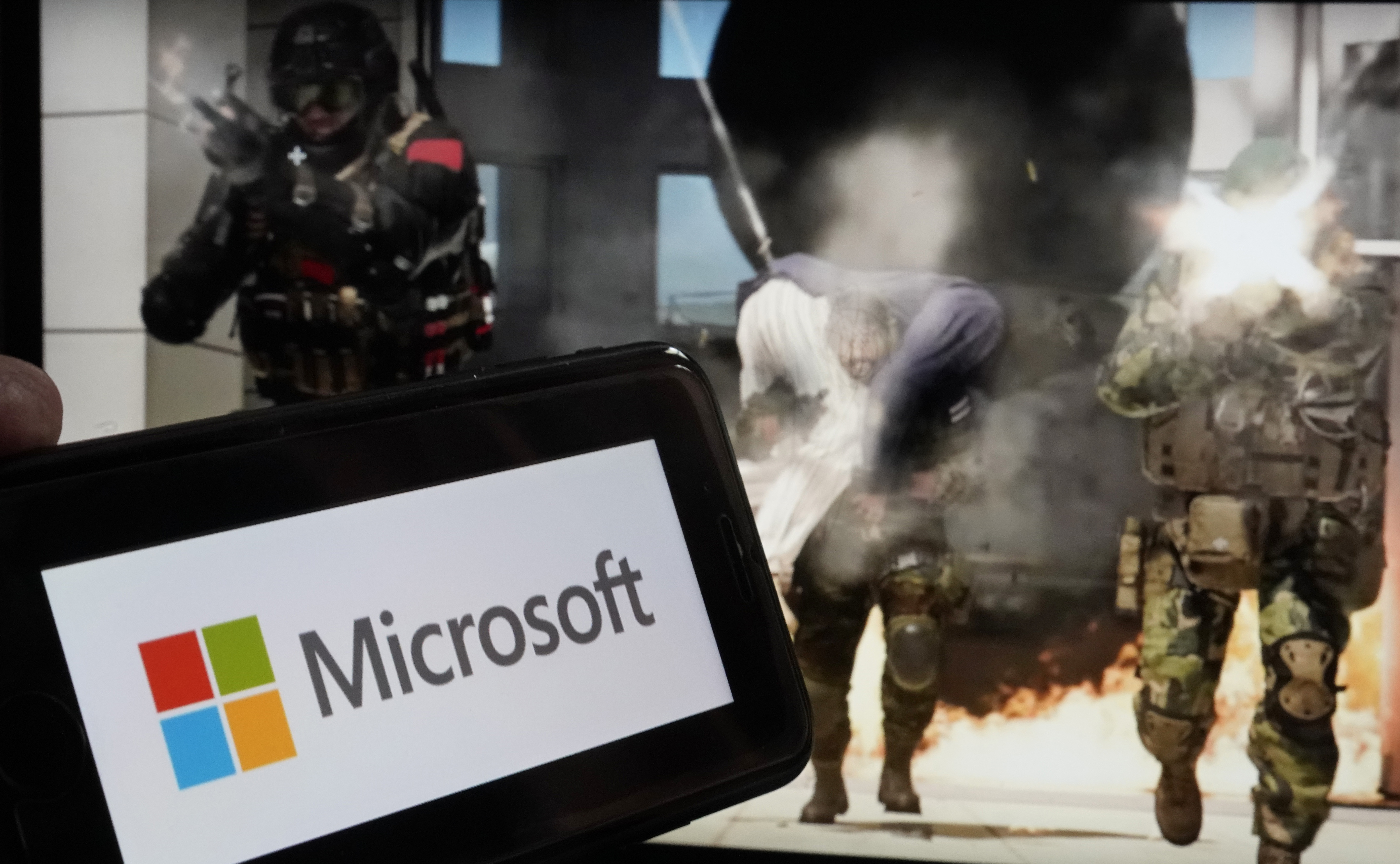 FILE - The logo for Microsoft, and a scene from Activision "Call of Duty - Modern Warfare," are shown in this photo, in New York, June 21, 2023. (AP Photo/Richard Drew, File)