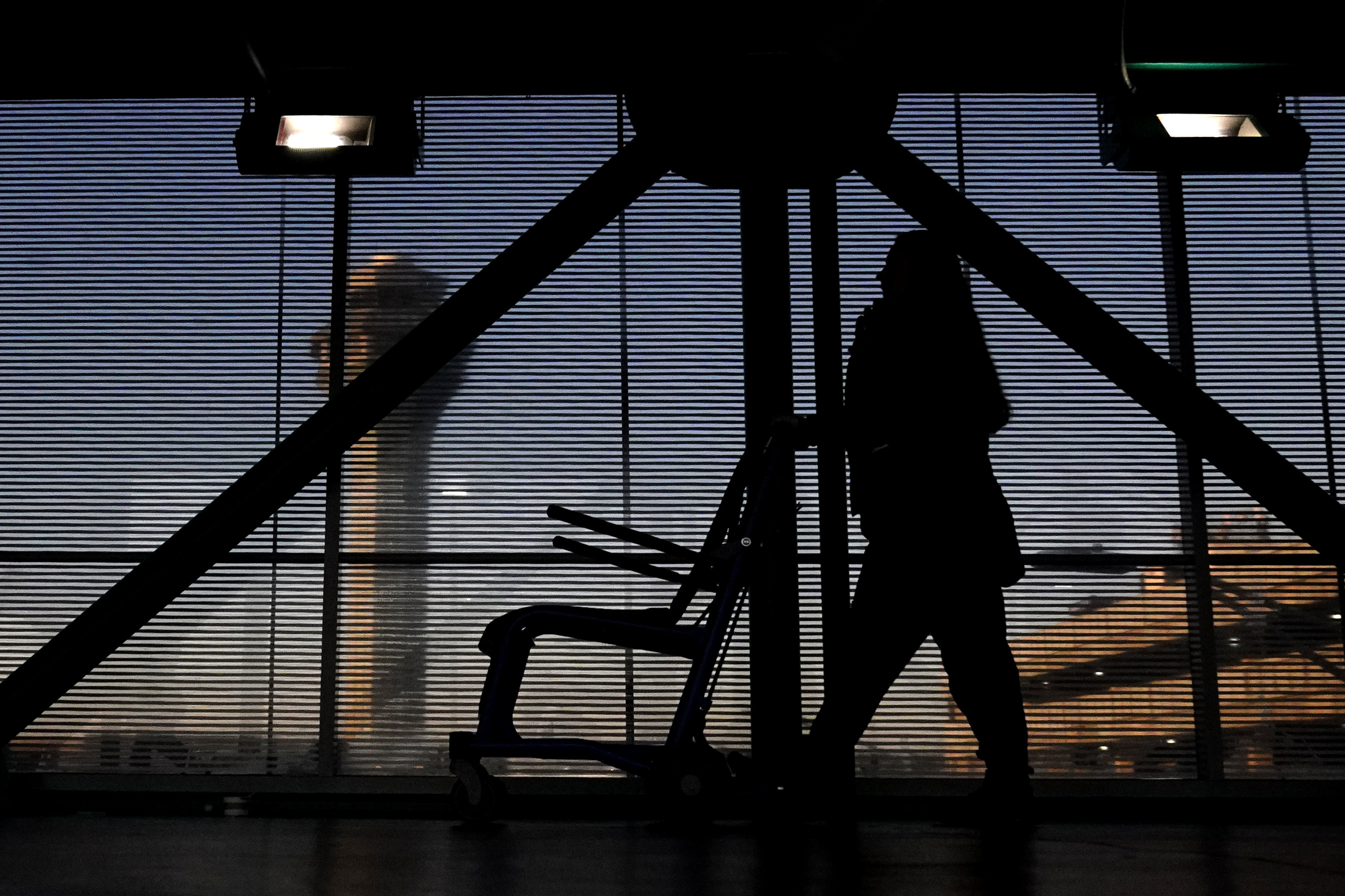 FILE - An airline employee transfers a wheelchair to her station at O'Hare International Airport in Chicago, Nov. 23, 2022. (AP Photo/Nam Y. Huh, File)