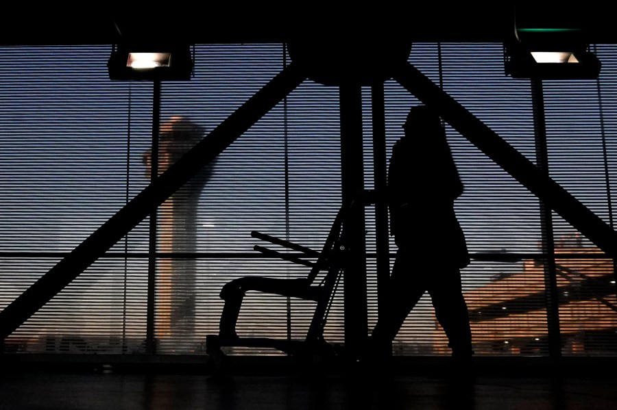 FILE - An airline employee transfers a wheelchair to her station at O'Hare International Airport in Chicago, Nov. 23, 2022. (AP Photo/Nam Y. Huh, File)