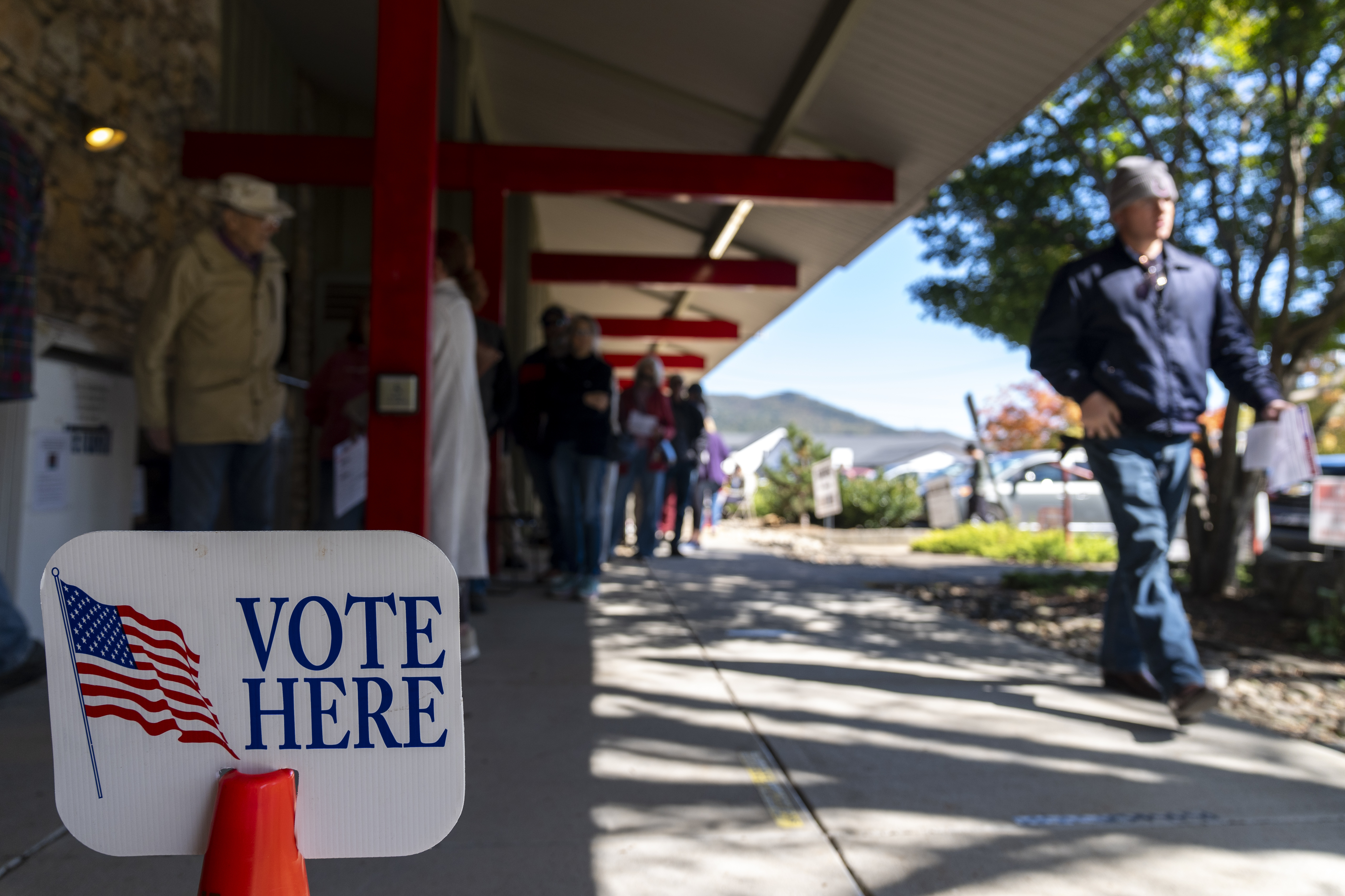 People wait in line at the polling place at Black Mountain Library during the first day of early in-person voting, on Oct. 17, 2024, in Black Mountain, N.C. (AP Photo/Stephanie Scarbrough)