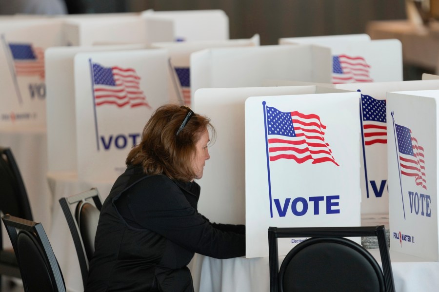 FILE - A voter fills out her ballot for the Michigan primary election in Grosse Pointe Farms, Mich., Tuesday, Feb. 27, 2024. (AP Photo/Paul Sancya, File)