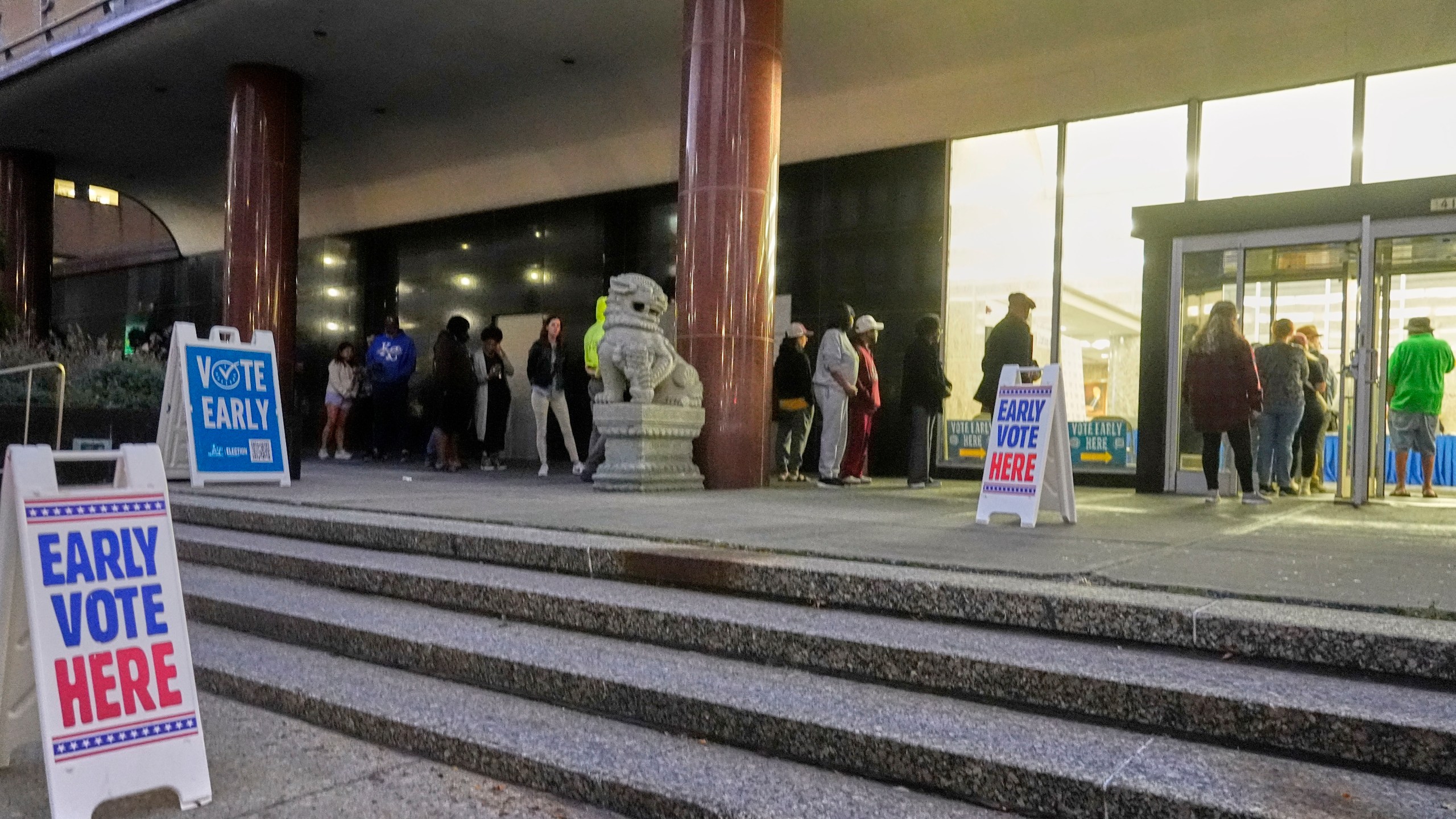 People line up outside the Frank P. Zeidler Municipal Building during the first day of Wisconsin's in-person absentee voting Tuesday, Oct. 22, 2024, in Milwaukee. (AP Photo/Morry Gash)