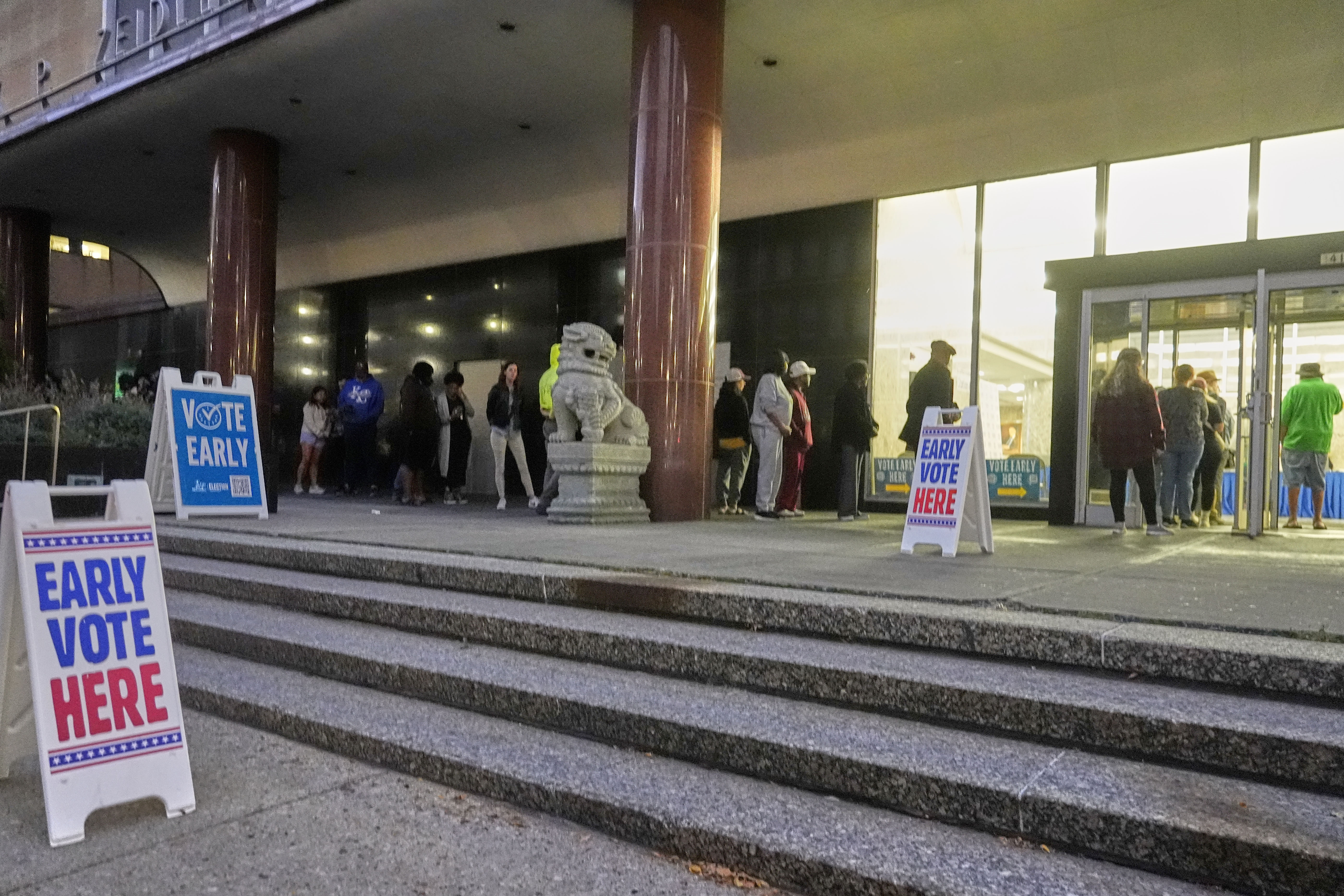 People line up outside the Frank P. Zeidler Municipal Building during the first day of Wisconsin's in-person absentee voting Tuesday, Oct. 22, 2024, in Milwaukee. (AP Photo/Morry Gash)