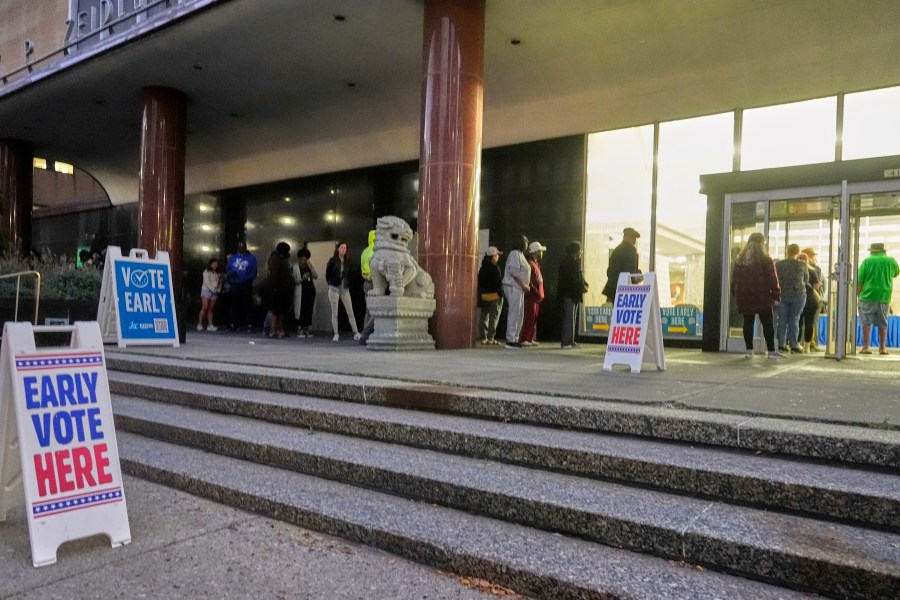 People line up outside the Frank P. Zeidler Municipal Building during the first day of Wisconsin's in-person absentee voting Tuesday, Oct. 22, 2024, in Milwaukee. (AP Photo/Morry Gash)