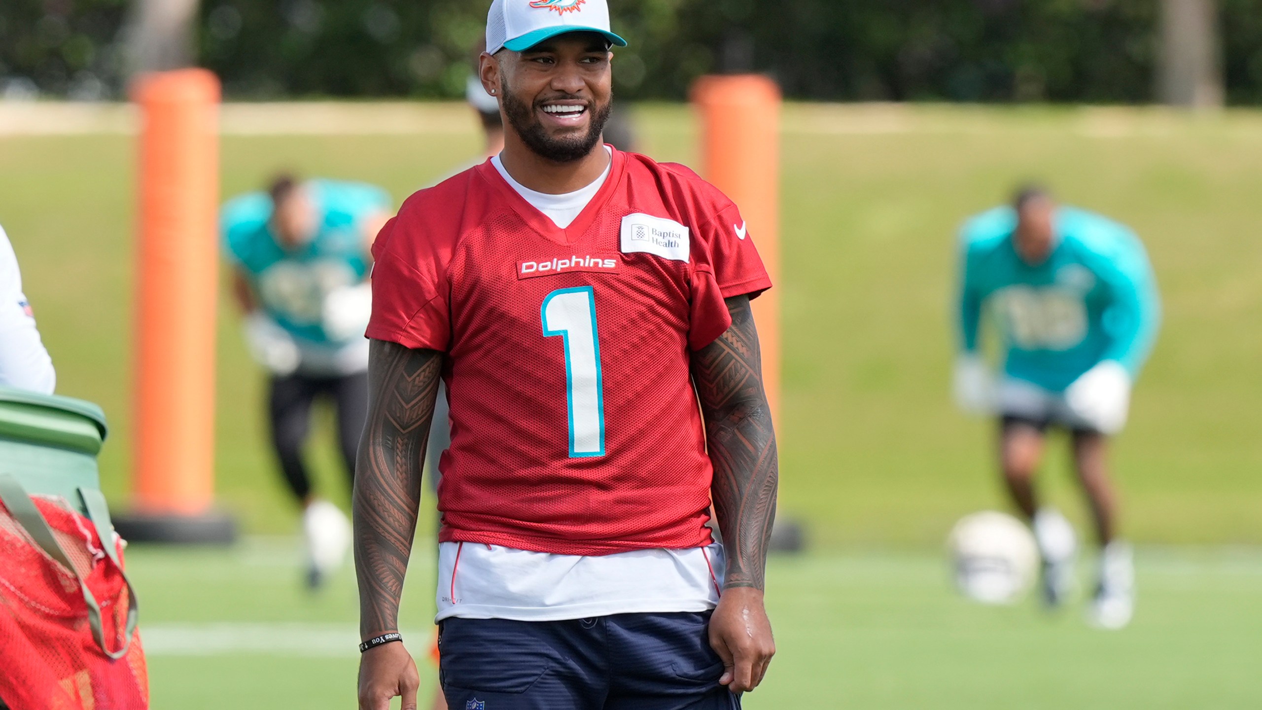 Miami Dolphins quarterback Tua Tagovailoa (1) smiles during a practice session at the team's training facility, Wednesday, Oct. 23, 2024, in Miami Gardens, Fla. (AP Photo/Marta Lavandier)