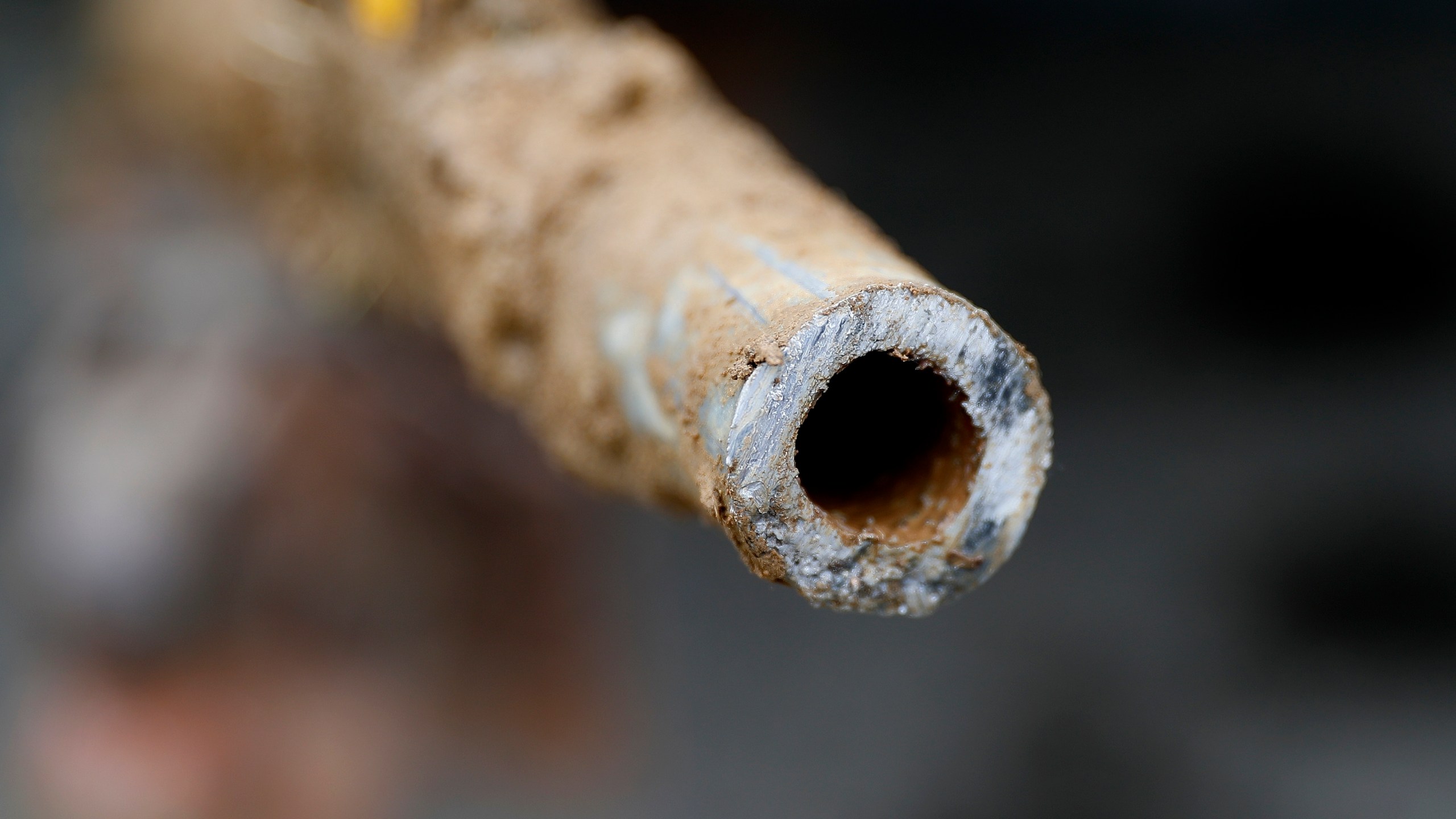 FILE - A lead pipe is shown after being replaced by a copper water supply line to a home in Flint, Mich., July 20, 2018. (AP Photo/Paul Sancya, File)