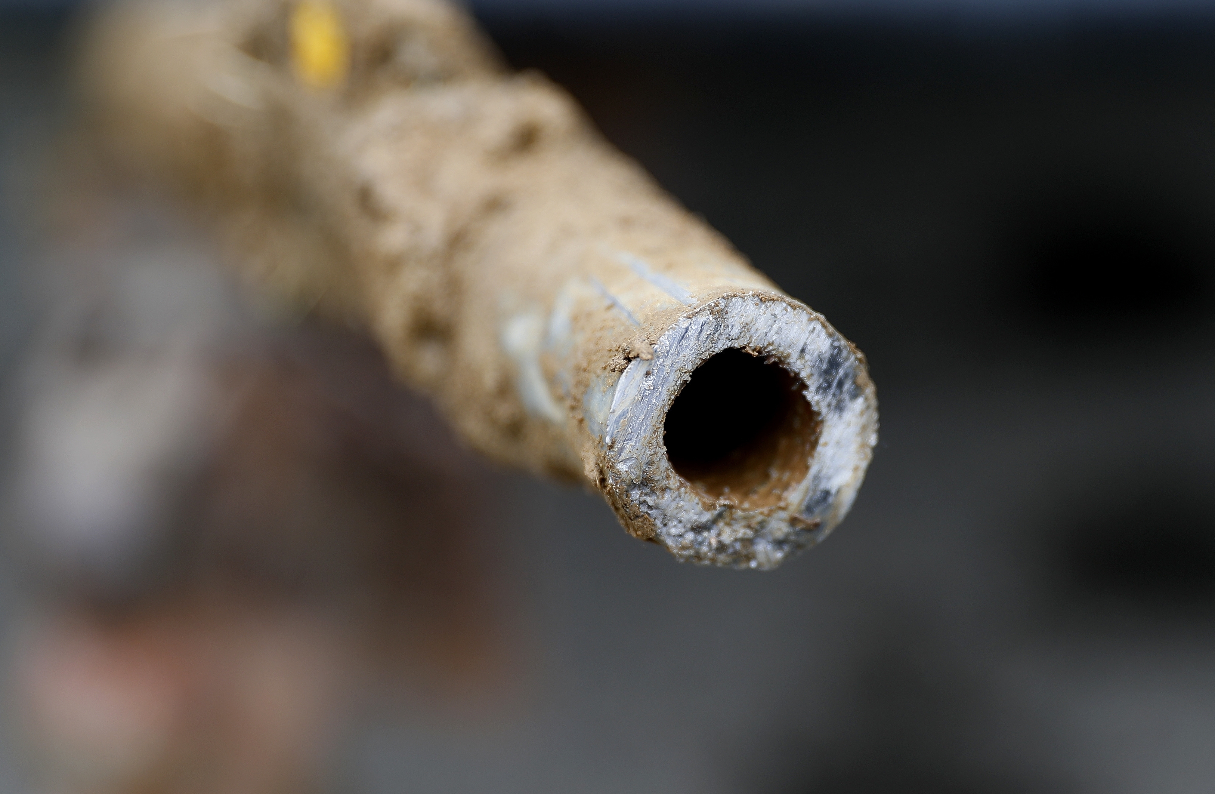 FILE - A lead pipe is shown after being replaced by a copper water supply line to a home in Flint, Mich., July 20, 2018. (AP Photo/Paul Sancya, File)