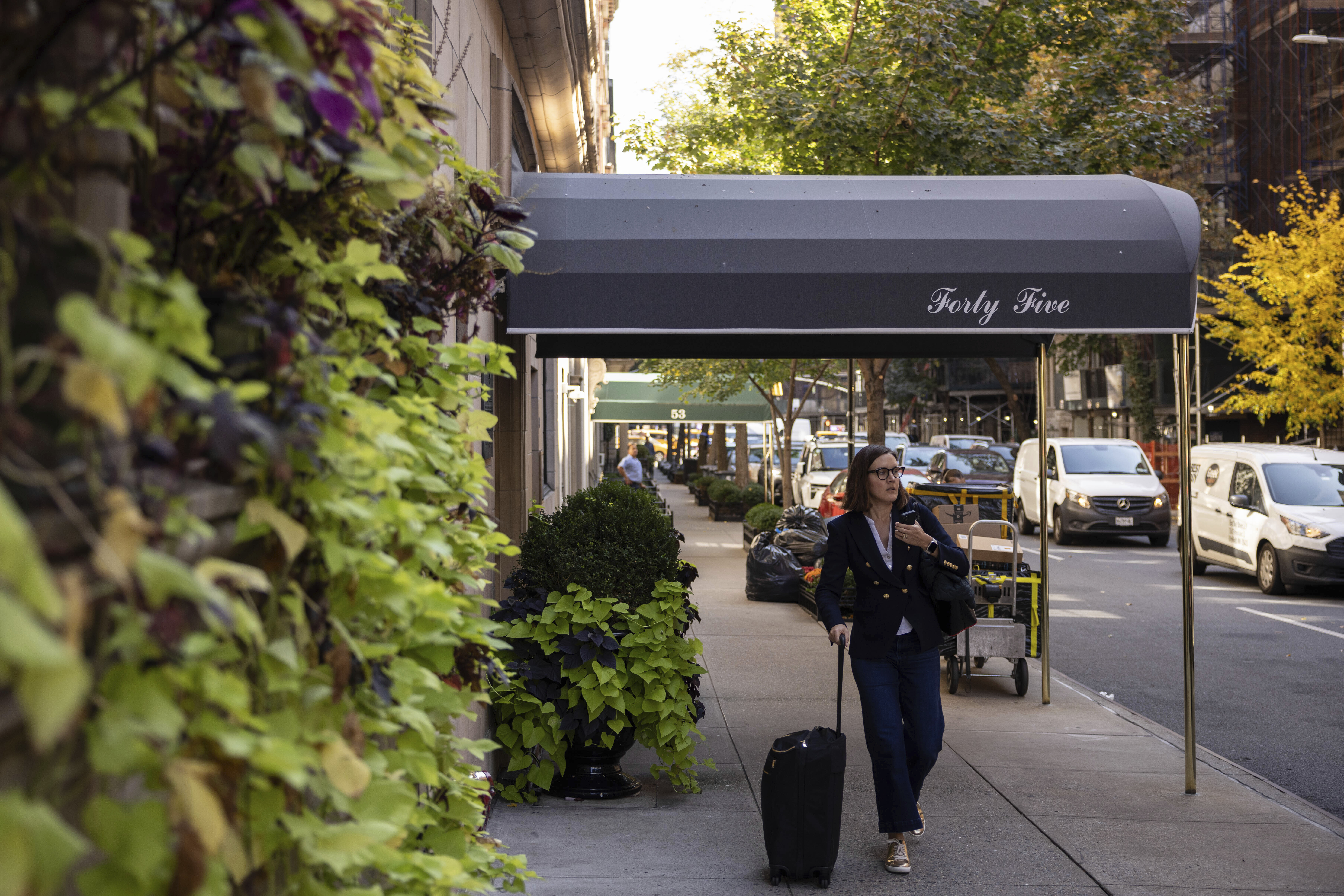 A person walks past the 45 East 66th Street, a building that includes an apartment owned by former New York City Mayor Rudy Giuliani, Wednesday, Oct. 23, 2024, in New York. (AP Photo/Yuki Iwamura)