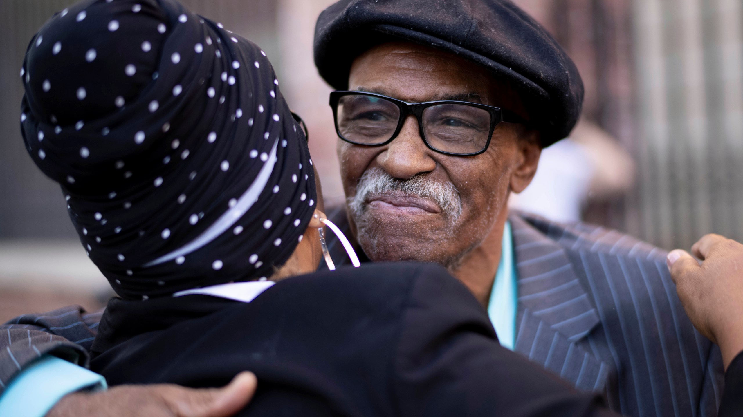 Herbert Rice, 79, right, is embraced by Adrianne Jones-Alston, on Wednesday, Oct. 23, 2024, in Philadelphia. (AP Photo/Laurence Kesterson)