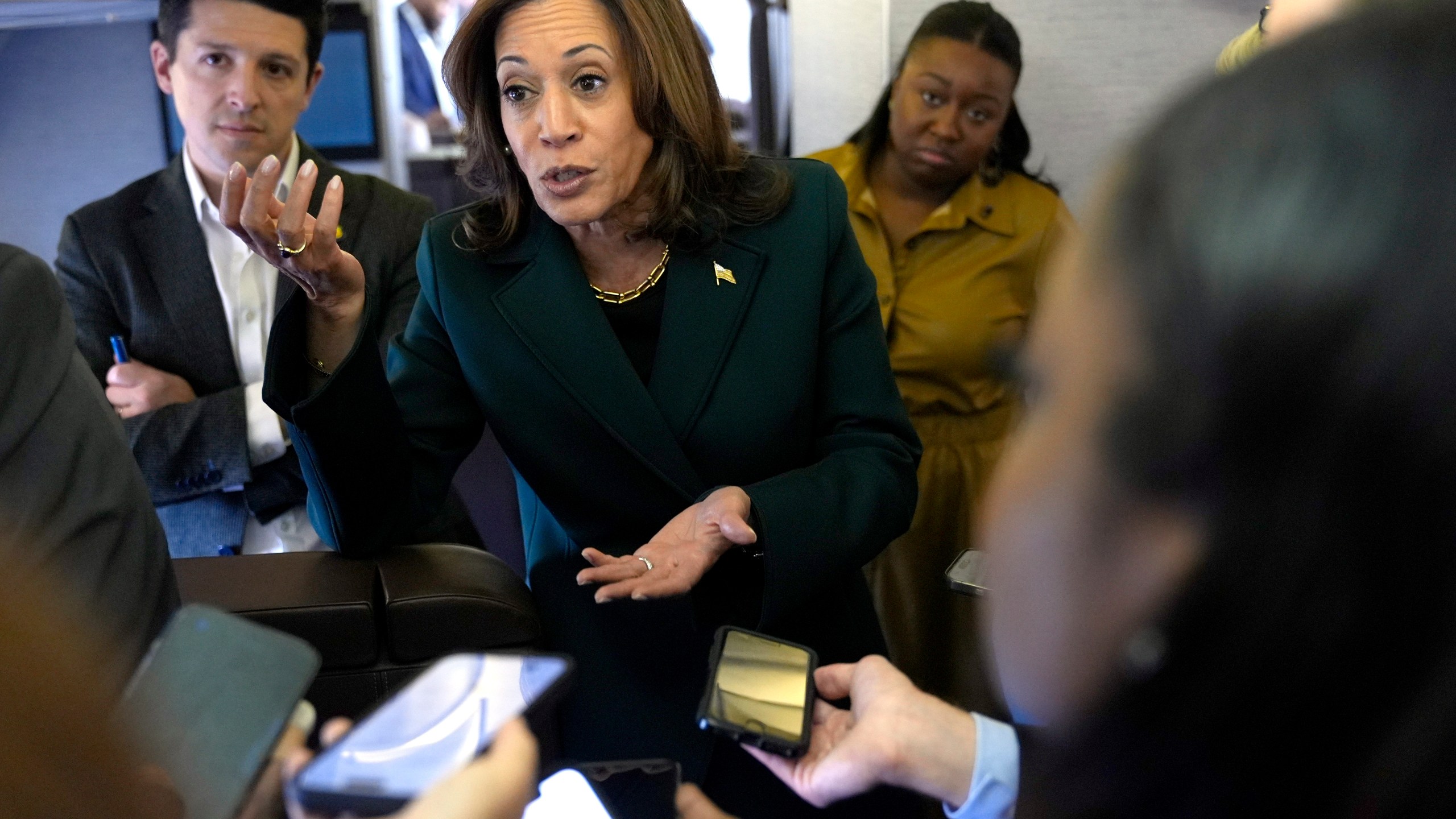 Democratic presidential nominee Vice President Kamala Harris speaks with members of the press on board Air Force Two at Philadelphia International Airport, Monday, Oct. 21, 2024, in Philadelphia, before departing to Michigan. (AP Photo/Jacquelyn Martin, Pool)