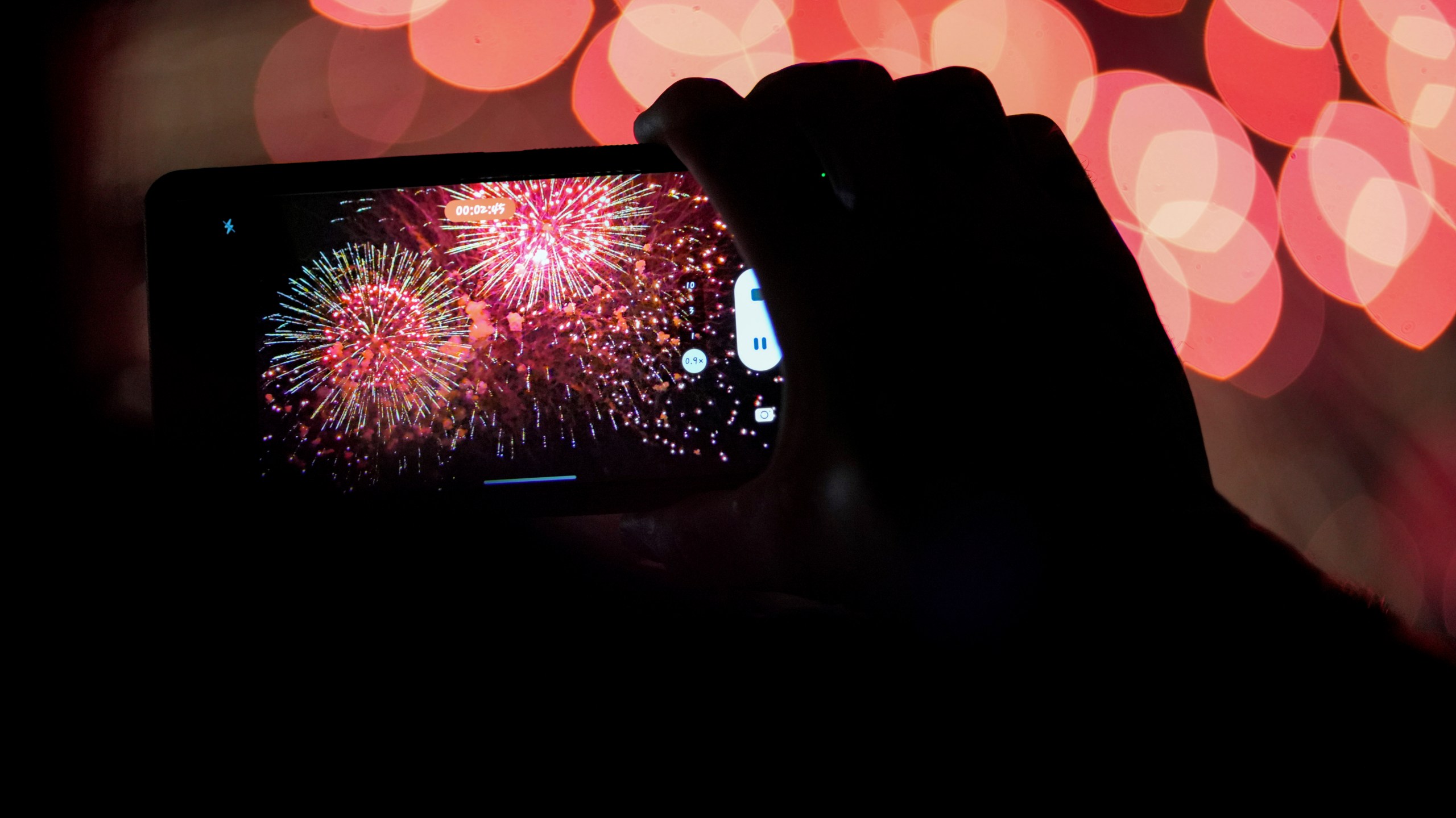 FILE - A spectator records a cell phone video as fireworks are launched over the Ohio River during the Western & Southern WEBN Fireworks show in Cincinnati on Sept. 3, 2023, in Cincinnati. (AP Photo/Aaron Doster)