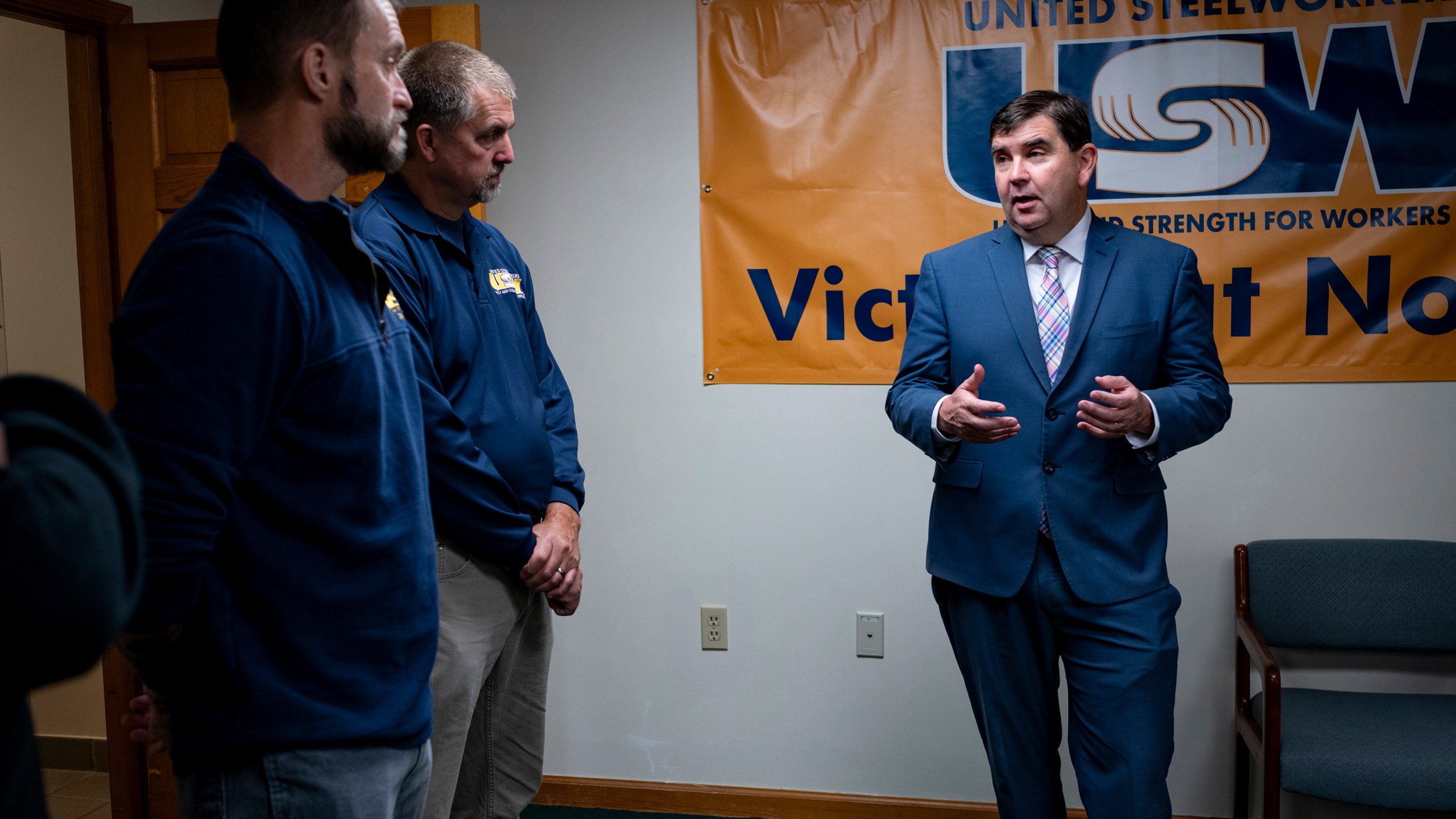 From left, Cary Eldridge, United Steelworkers (USW) Sub District Director, Syracuse office, and Jack Vanderbaan USW Staff, Syracuse, listen as New York State Senator John Mannion, Democratic candidate for New York's 22nd congressional district, meets with representatives and members of the United Steelworkers in Geddes, N.Y. Thursday. Oct. 24. 2024. (AP Photo/Craig Ruttle)