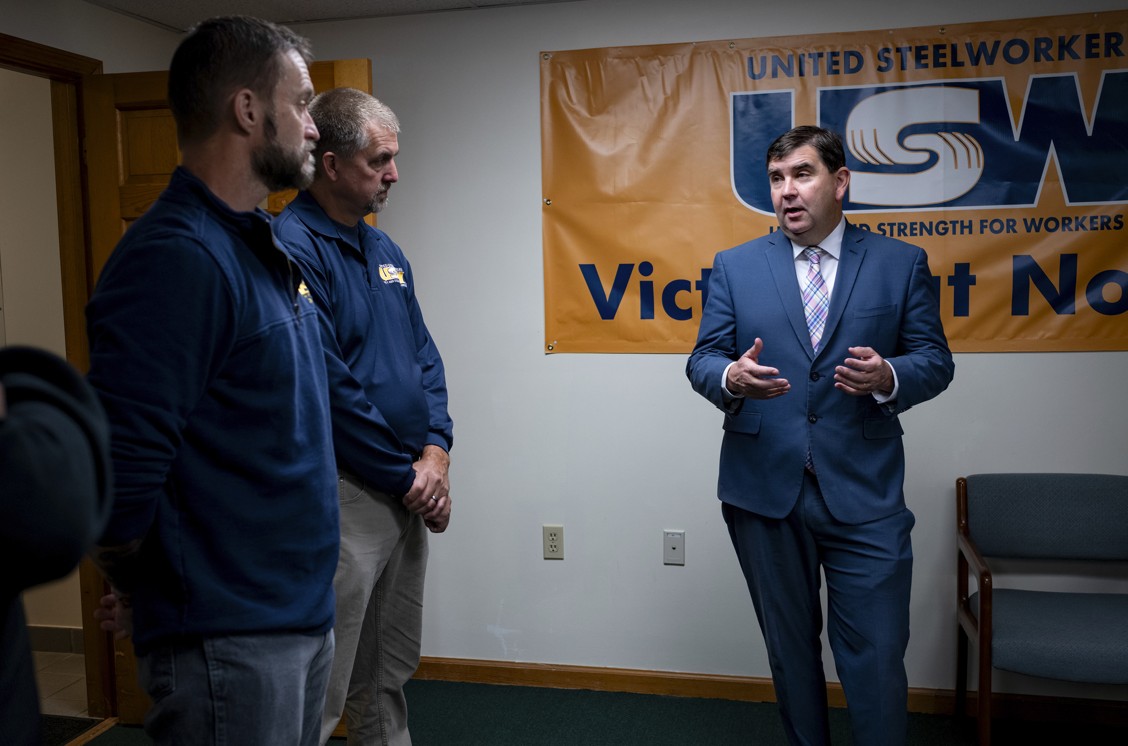 From left, Cary Eldridge, United Steelworkers (USW) Sub District Director, Syracuse office, and Jack Vanderbaan USW Staff, Syracuse, listen as New York State Senator John Mannion, Democratic candidate for New York's 22nd congressional district, meets with representatives and members of the United Steelworkers in Geddes, N.Y. Thursday. Oct. 24. 2024. (AP Photo/Craig Ruttle)