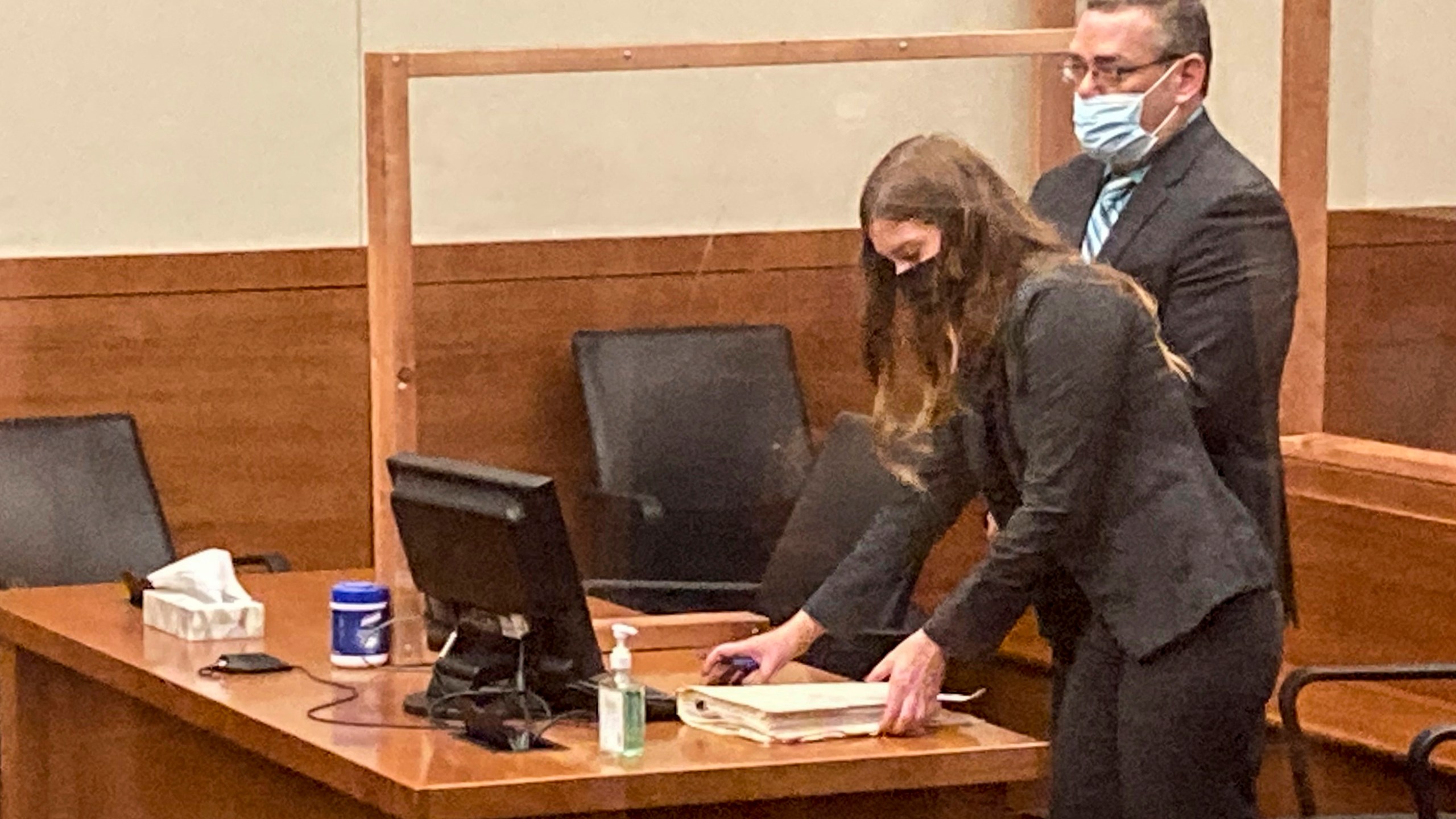 FILE - Former Ohio police officer Adam Coy stands during a Franklin County hearing as defense attorney Kaitlyn Stephens checks her notes, Oct. 4, 2021, in Columbus, Ohio. (AP Photo/Andrew Welsh-Huggins, File)