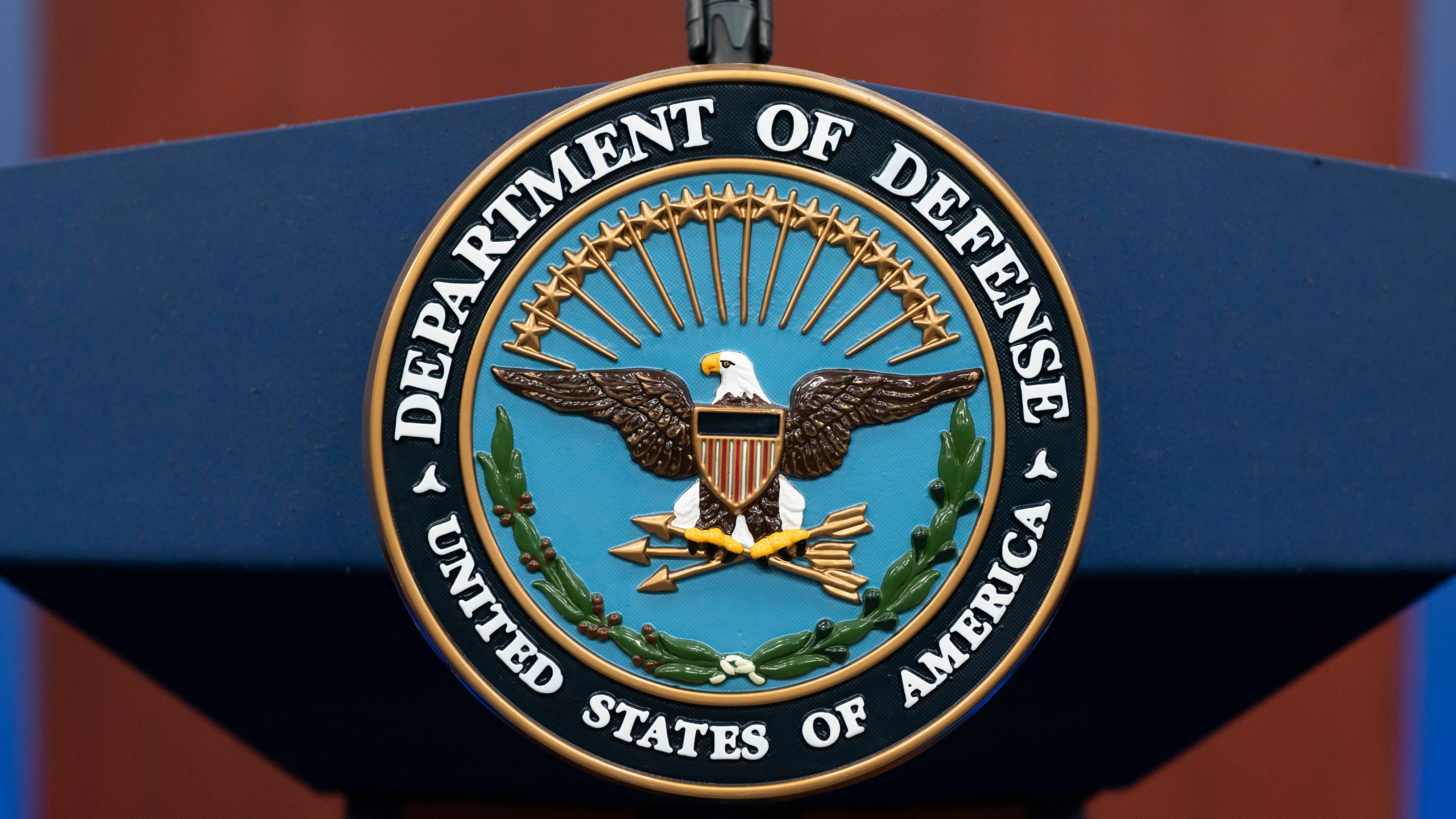 FILE - The seal of the Department of Defense is seen on the podium at the Pentagon, Sept. 27, 2022, in Washington. The Pentagon says the U.S. is sending an additional “few thousand” troops to the Middle East to bolster security and to be prepared to defend Israel if necessary. (AP Photo/Alex Brandon, File)