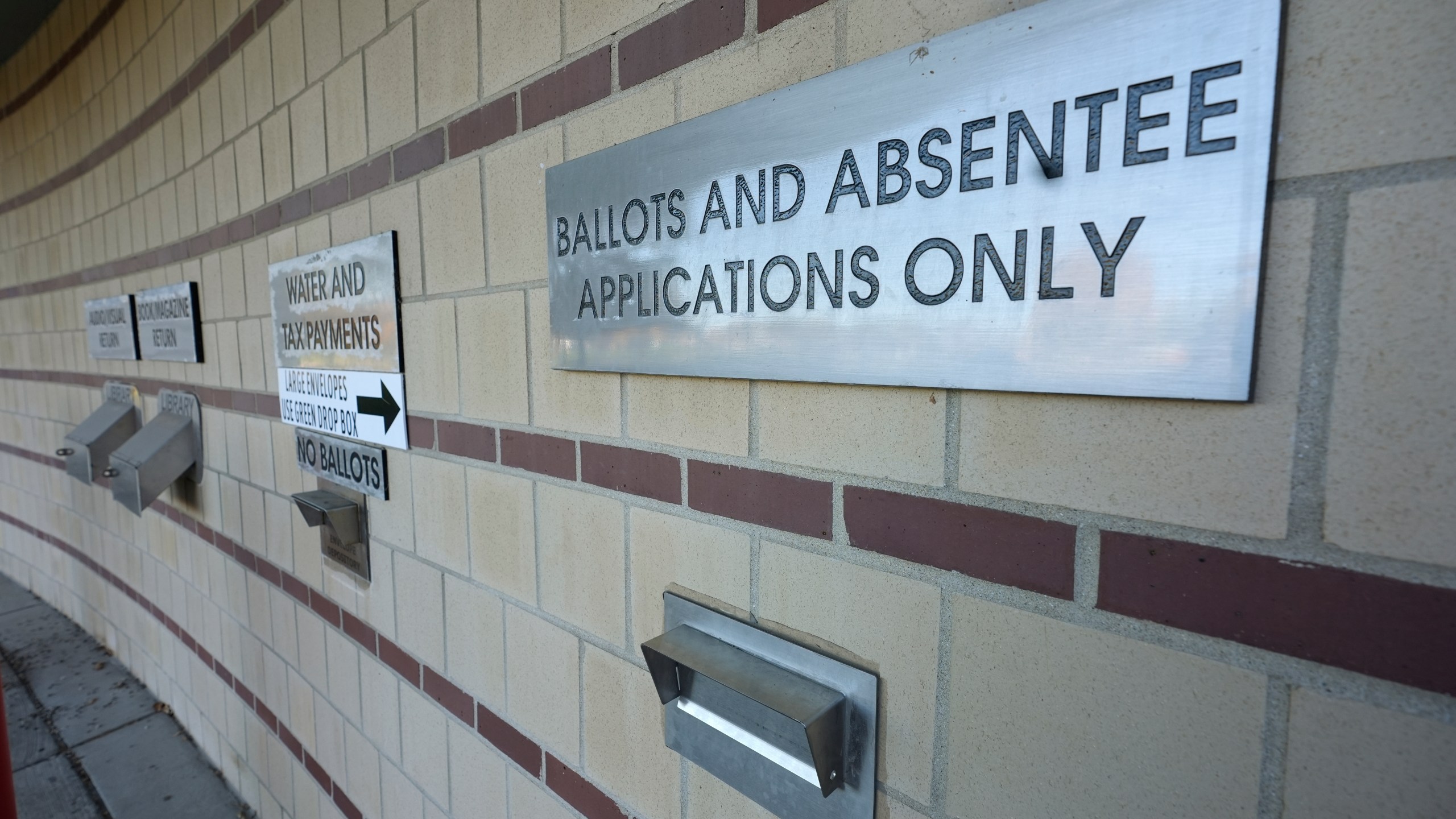 A drop slot for voting ballots and absentee applications is shown outside of the Warren City Hall complex Thursday, Oct. 24, 2024, in Warren, Mich. (AP Photo/Paul Sancya)