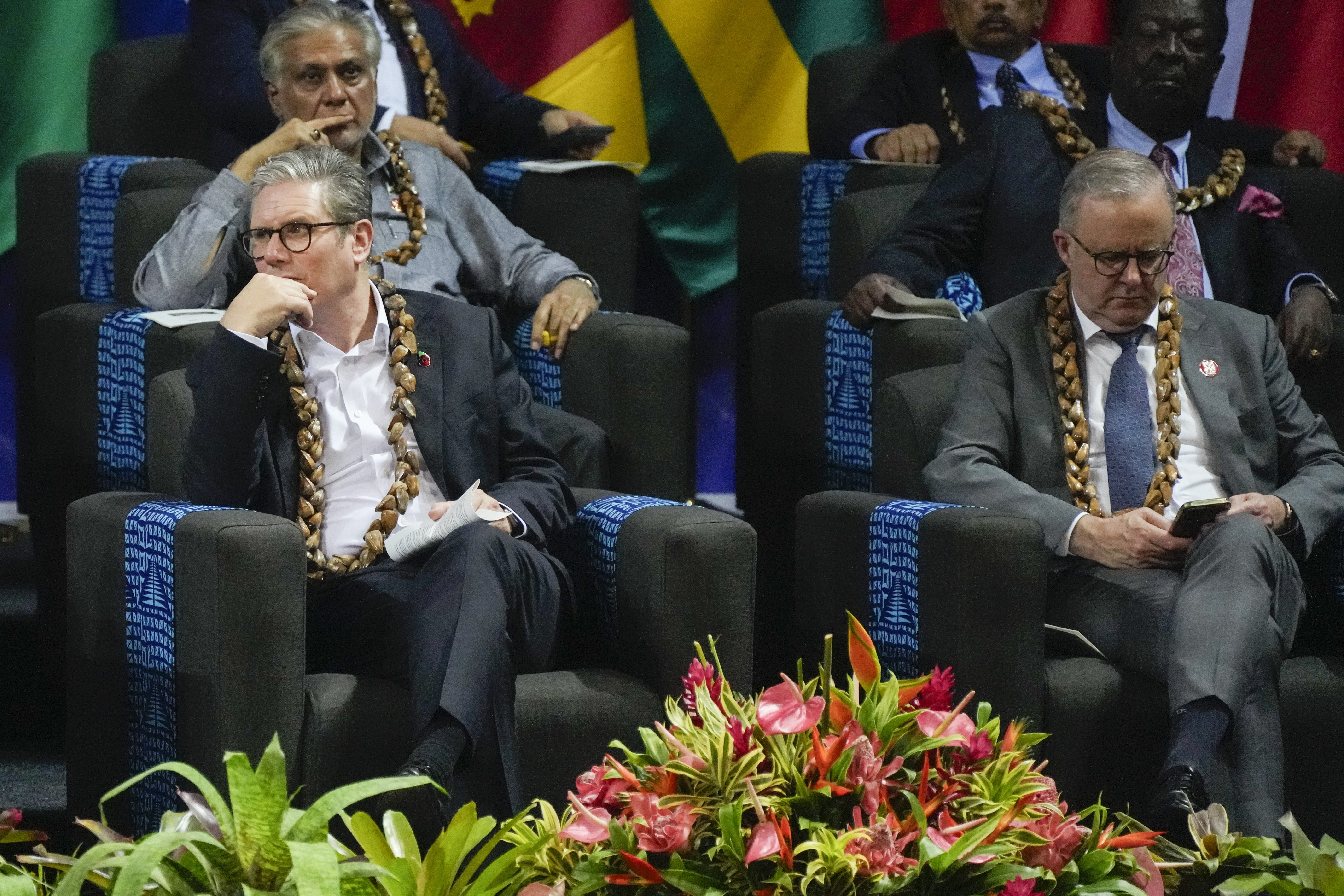 British Prime Minister Keir Starmer, left, and Australian Prime Minister Anthony Albanese react during the opening ceremony for the Commonwealth Heads of Government meeting in Apia, Samoa, Friday, Oct. 25, 2024. (AP Photo/Rick Rycroft/Pool)