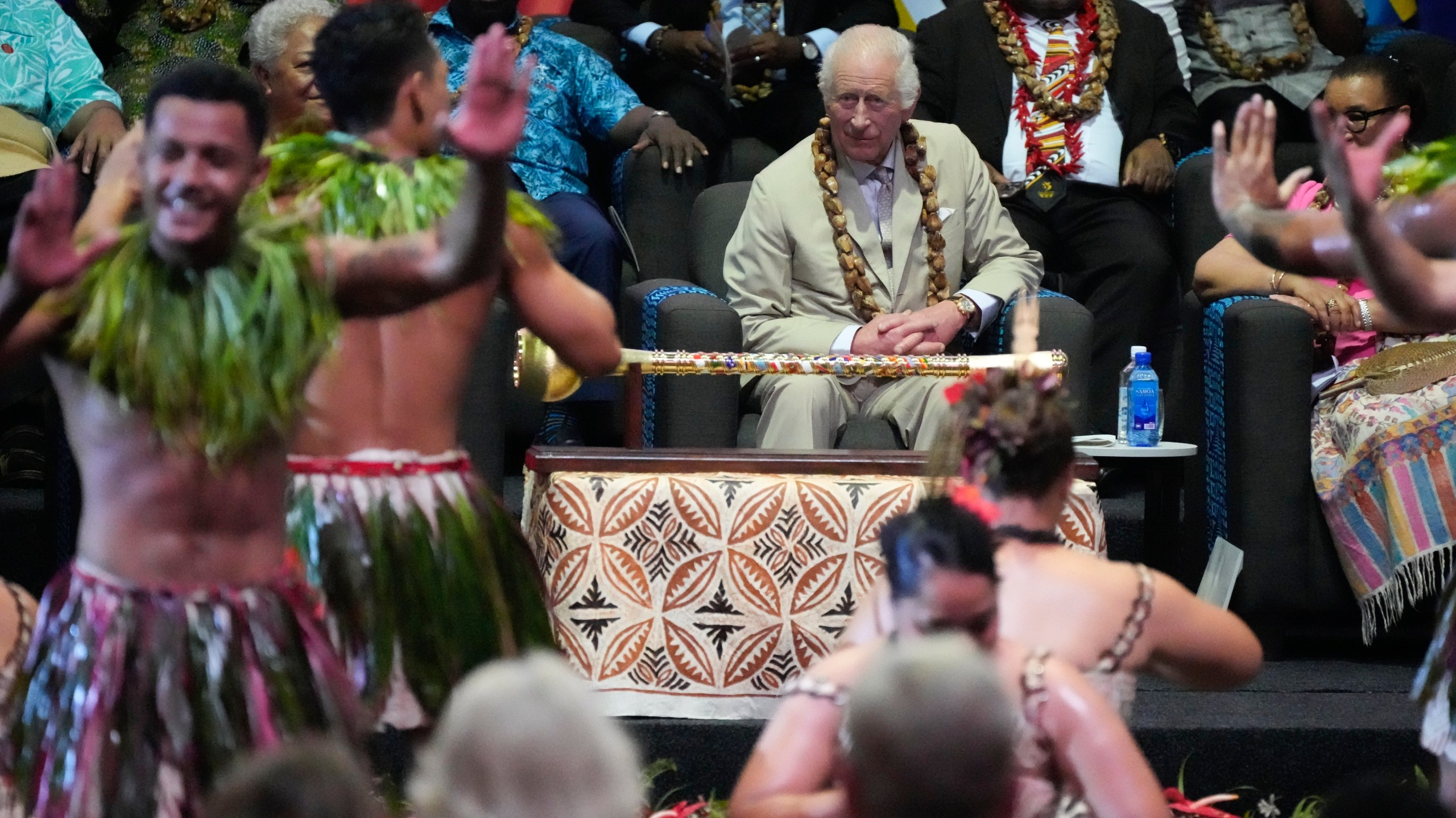 Britain's King Charles watches dancers perform during the opening ceremony for the Commonwealth Heads of Government meeting in Apia, Samoa, Friday, Oct. 25, 2024. (AP Photo/Rick Rycroft/Pool)