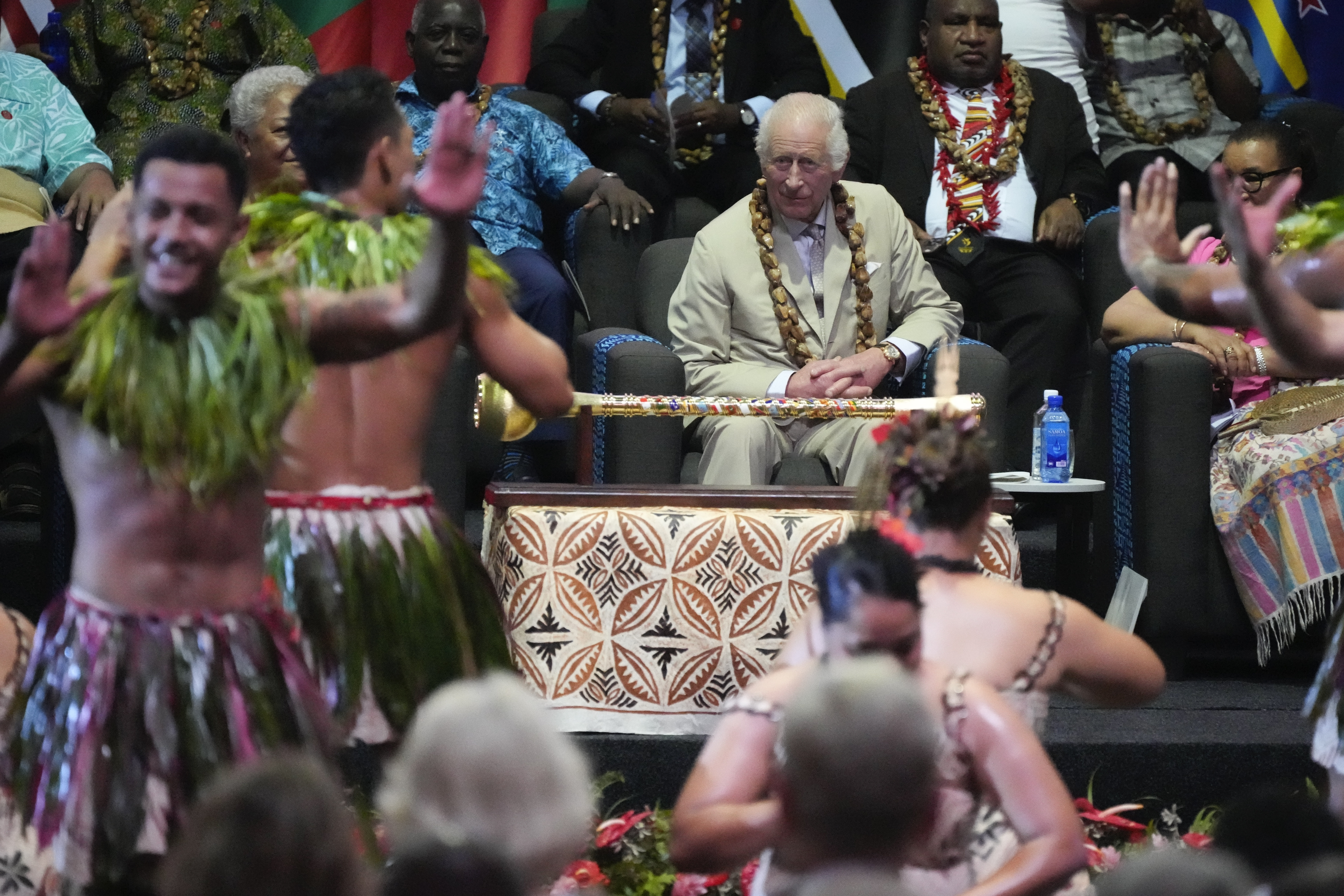 Britain's King Charles watches dancers perform during the opening ceremony for the Commonwealth Heads of Government meeting in Apia, Samoa, Friday, Oct. 25, 2024. (AP Photo/Rick Rycroft/Pool)