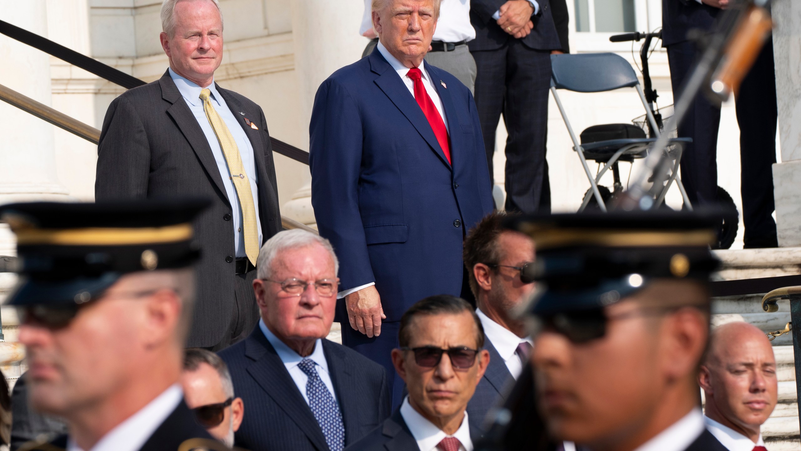 FILE - Republican presidential nominee former President Donald Trump, right, and Bob Quackenbush, deputy chief of staff for Arlington National Cemetery, watch the changing of the guard at the Tomb of the Unknown Solider at Arlington National Cemetery, Aug. 26, 2024, in Arlington, Va. (AP Photo/Alex Brandon, File)