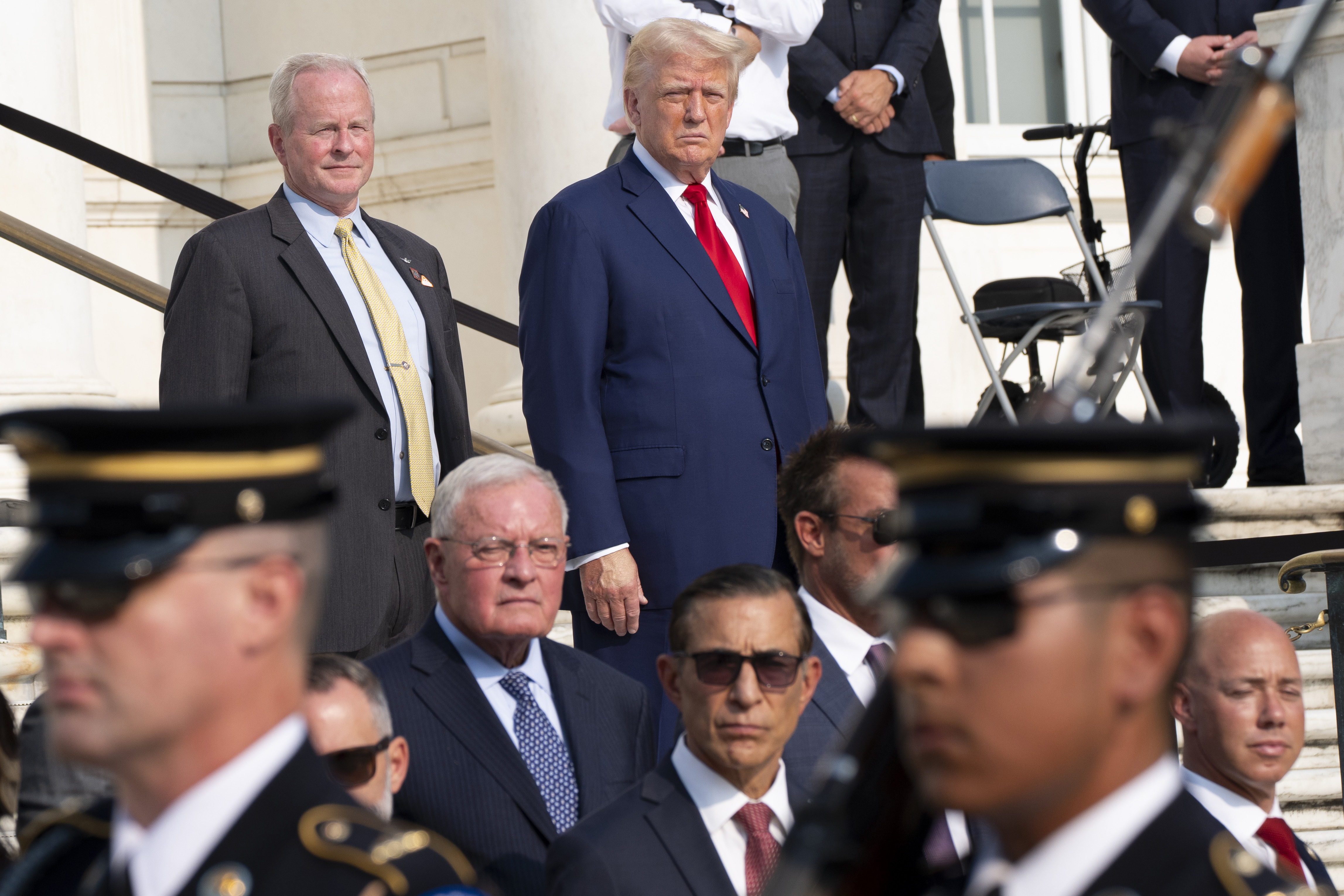 FILE - Republican presidential nominee former President Donald Trump, right, and Bob Quackenbush, deputy chief of staff for Arlington National Cemetery, watch the changing of the guard at the Tomb of the Unknown Solider at Arlington National Cemetery, Aug. 26, 2024, in Arlington, Va. (AP Photo/Alex Brandon, File)