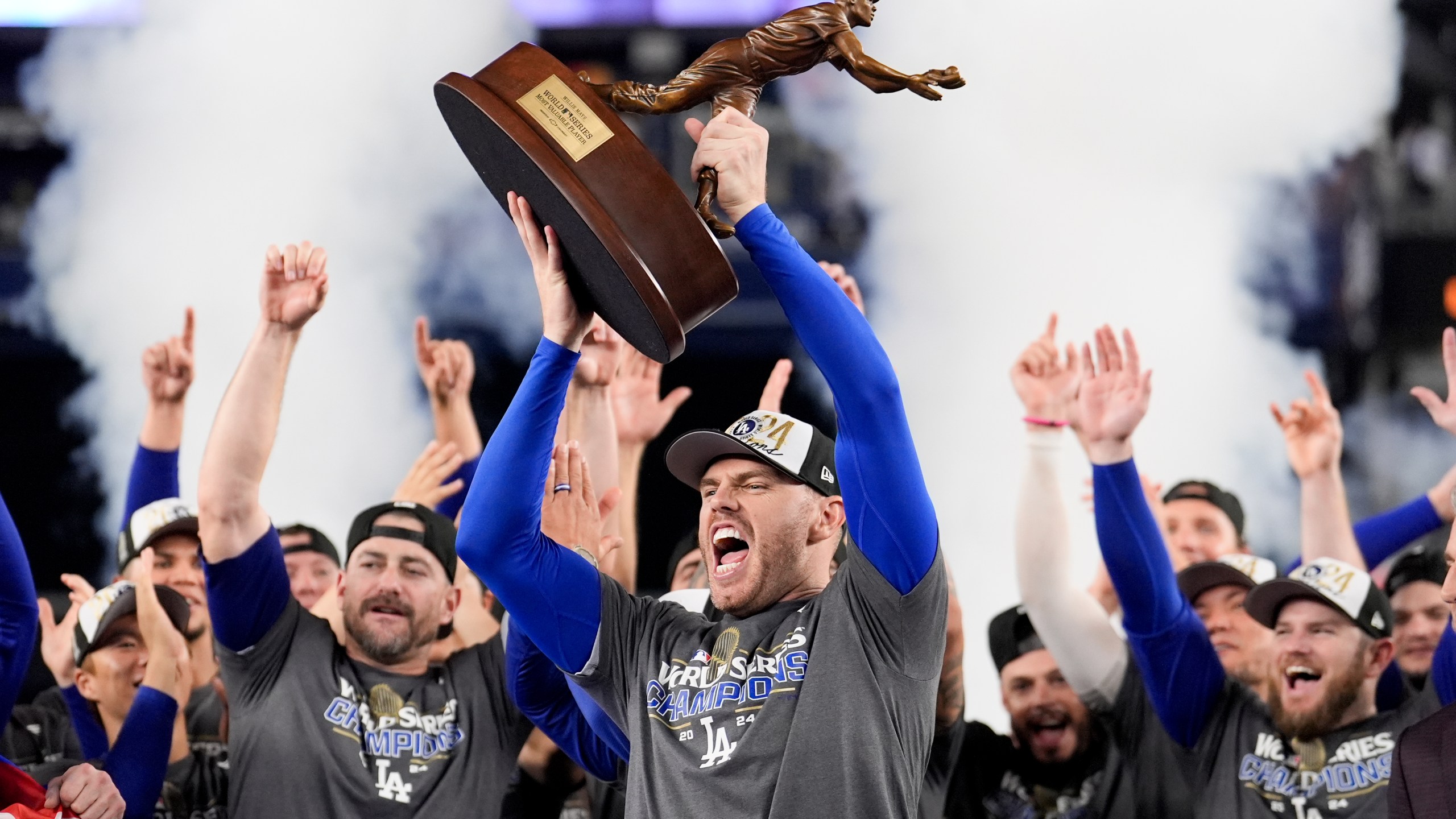 Los Angeles Dodgers' Freddie Freeman celebrates with the MVP trophy after their win against the New York Yankees in Game 5 to win the baseball World Series, Thursday, Oct. 31, 2024, in New York. (AP Photo/Ashley Landis)