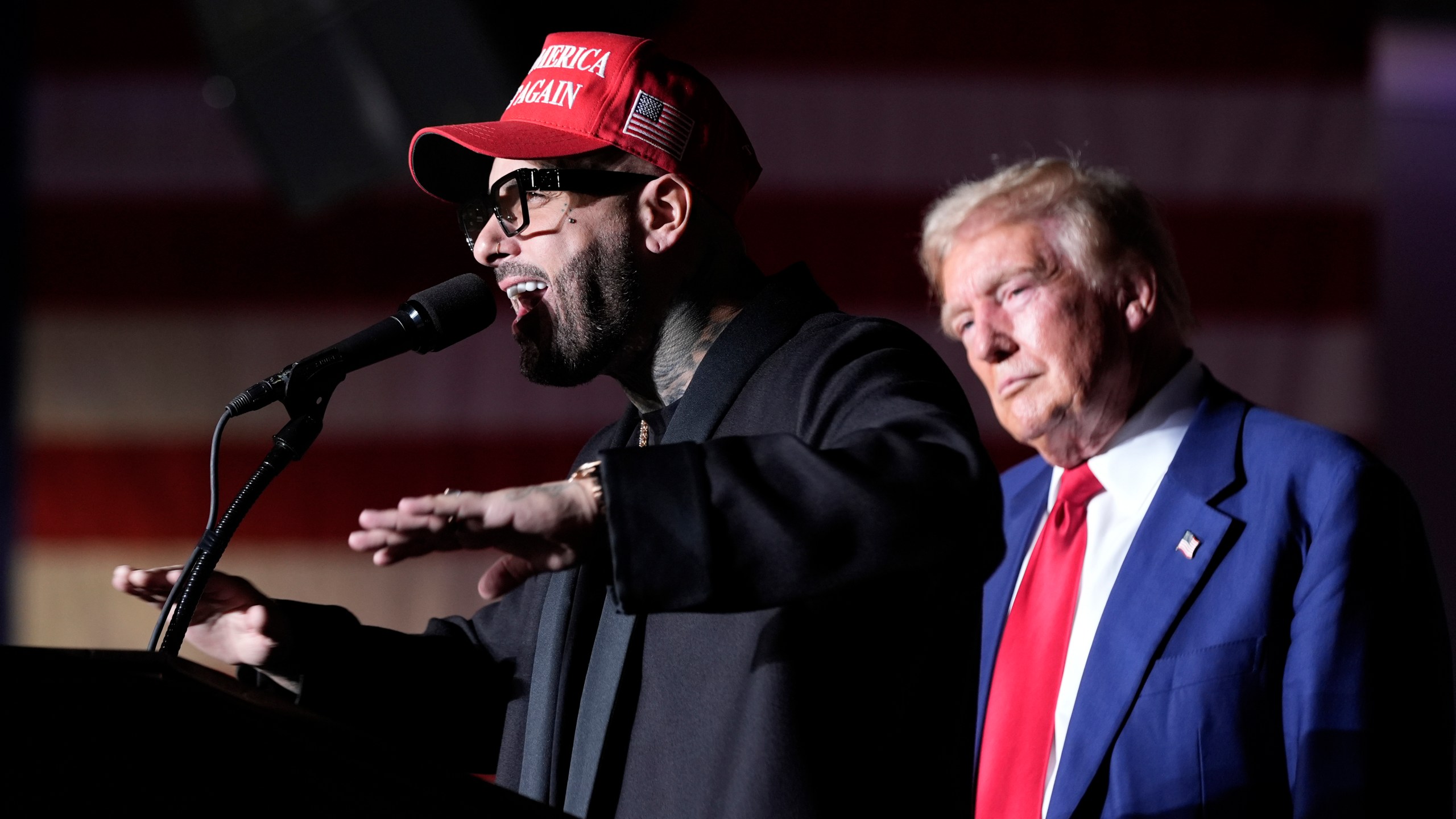 FILE - Nicky Jam speaks as Republican presidential nominee former President Donald Trump listens during a campaign event at the World Market Center, Sept. 13, 2024, in Las Vegas. (AP Photo/Alex Brandon, File)