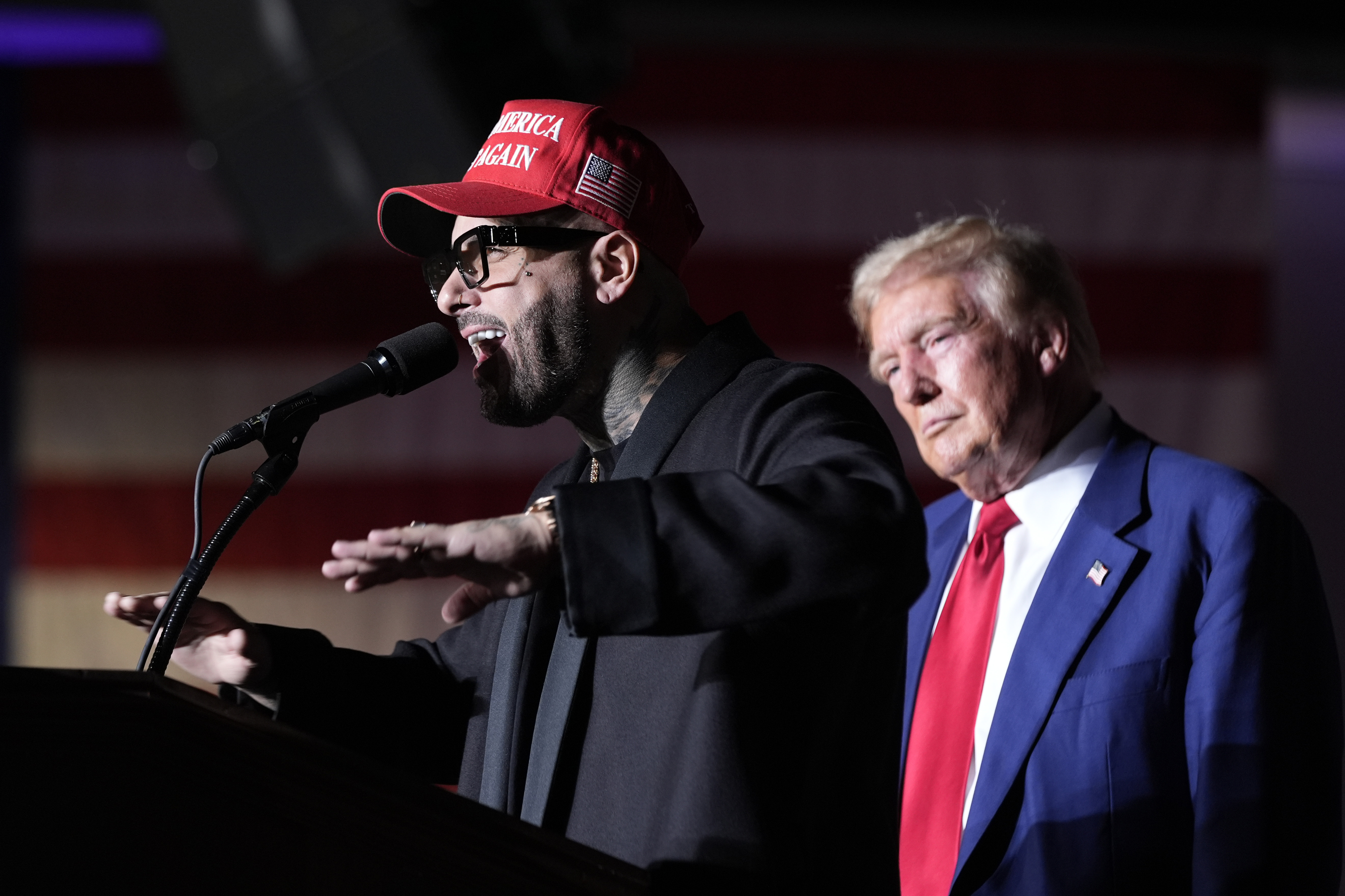 FILE - Nicky Jam speaks as Republican presidential nominee former President Donald Trump listens during a campaign event at the World Market Center, Sept. 13, 2024, in Las Vegas. (AP Photo/Alex Brandon, File)