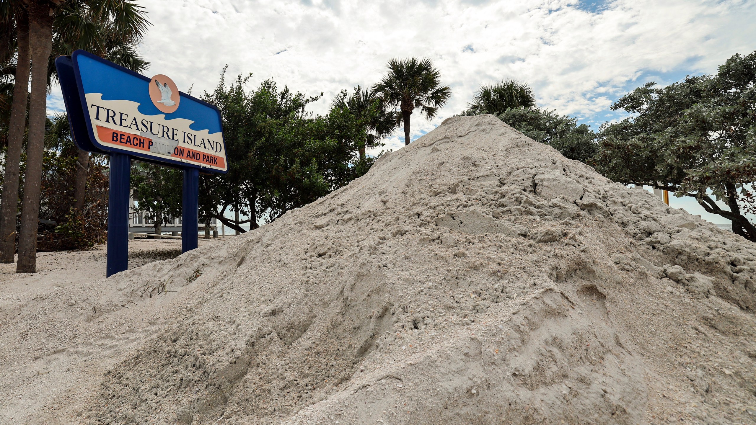 FILE - Sand washed ashore by the surge of Hurricane Helene is piled, Oct. 2, 2024, in Treasure Island, Fla. (AP Photo/Mike Carlson, File)