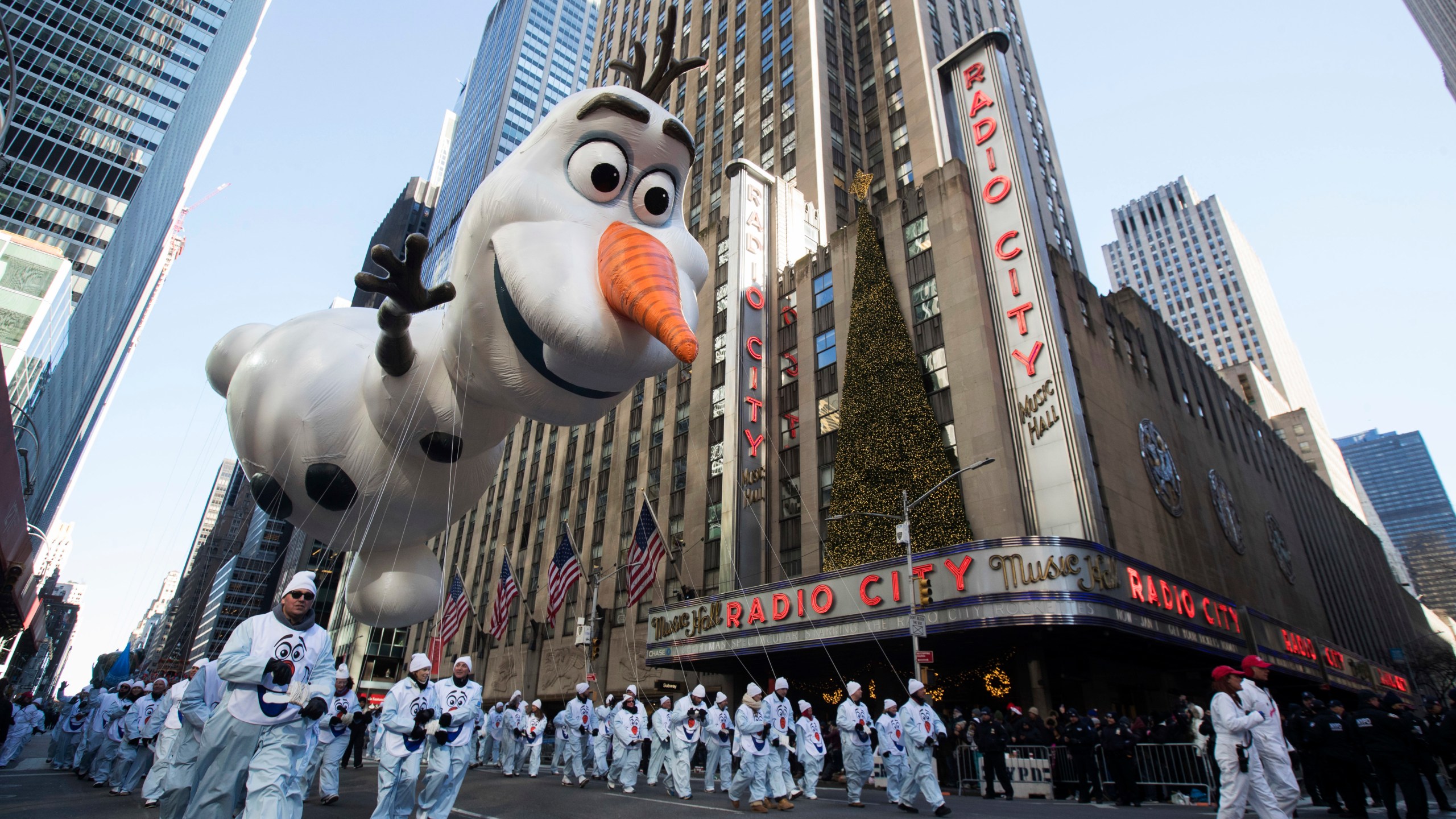 FILE - In this Nov. 22, 2018 file photo, the Olaf balloon floats past Radio City Music Hall during the 92nd annual Macy's Thanksgiving Day Parade in New York. (AP Photo/Mary Altaffer, File)