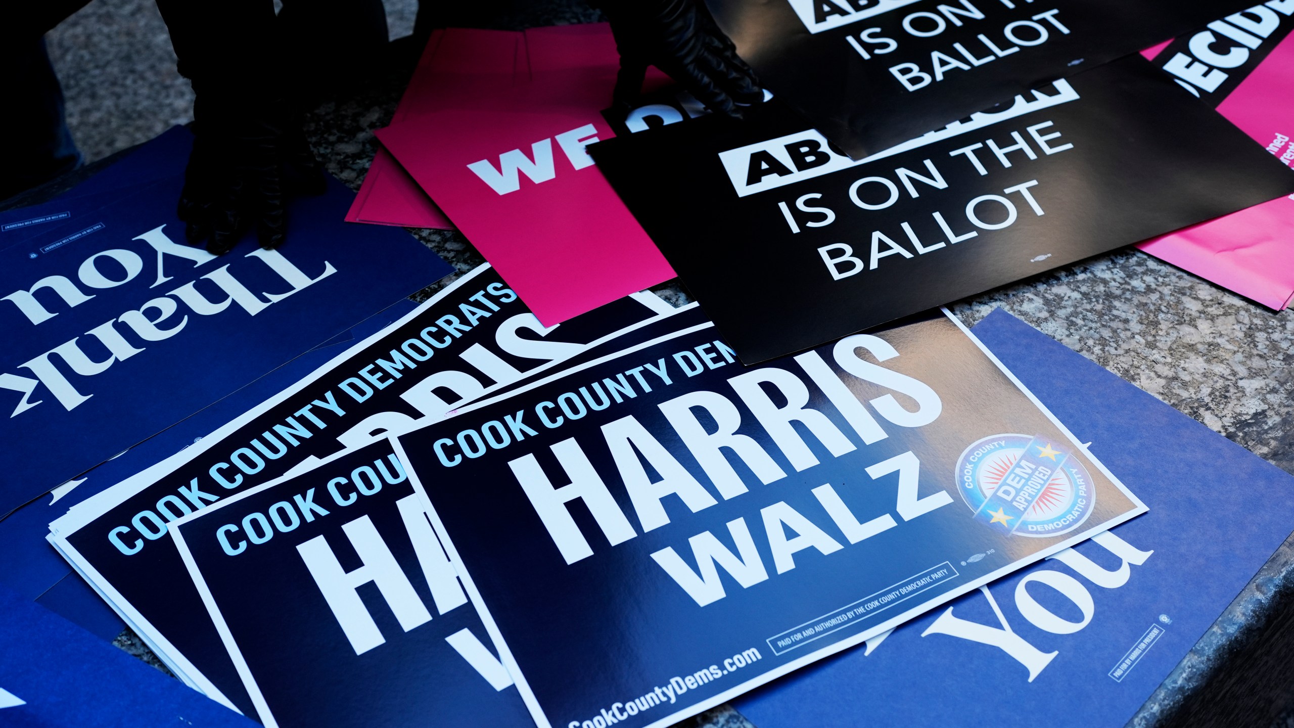 Signs are seen at National Women's March in Chicago, Saturday, Nov. 2, 2024. The Women's March movement launched the day after Donald Trump's inauguration, when hundreds of thousands of women poured into the District and across the country in what is widely considered the largest single-day protest in American history. (AP Photo/Nam Y. Huh)