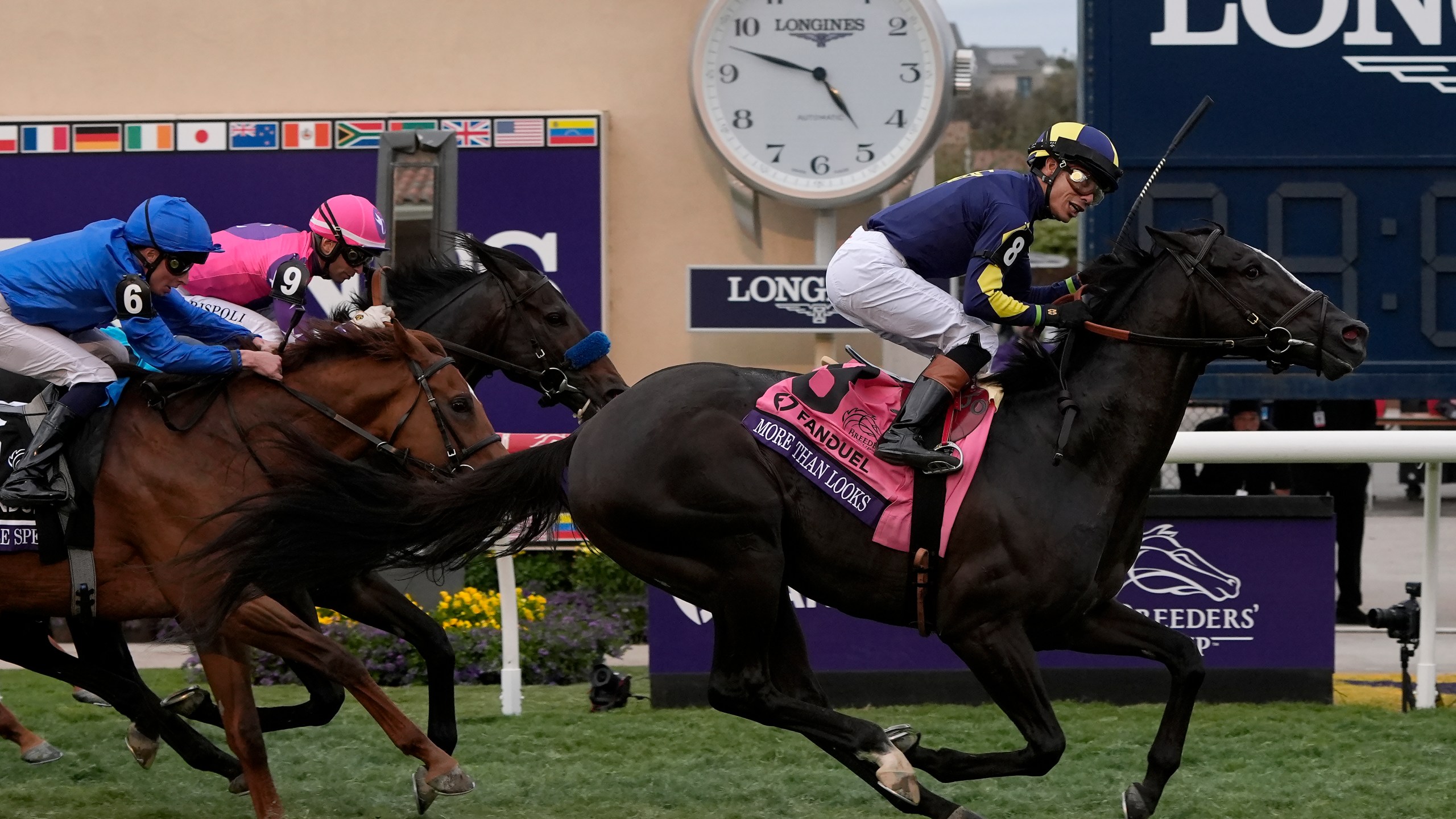 Jose Ortiz rides More Than Looks, right, to victory in the Breeders' Cup Mile horse race in Del Mar, Calif., Saturday, Nov. 2, 2024. (AP Photo/Gregory Bull)