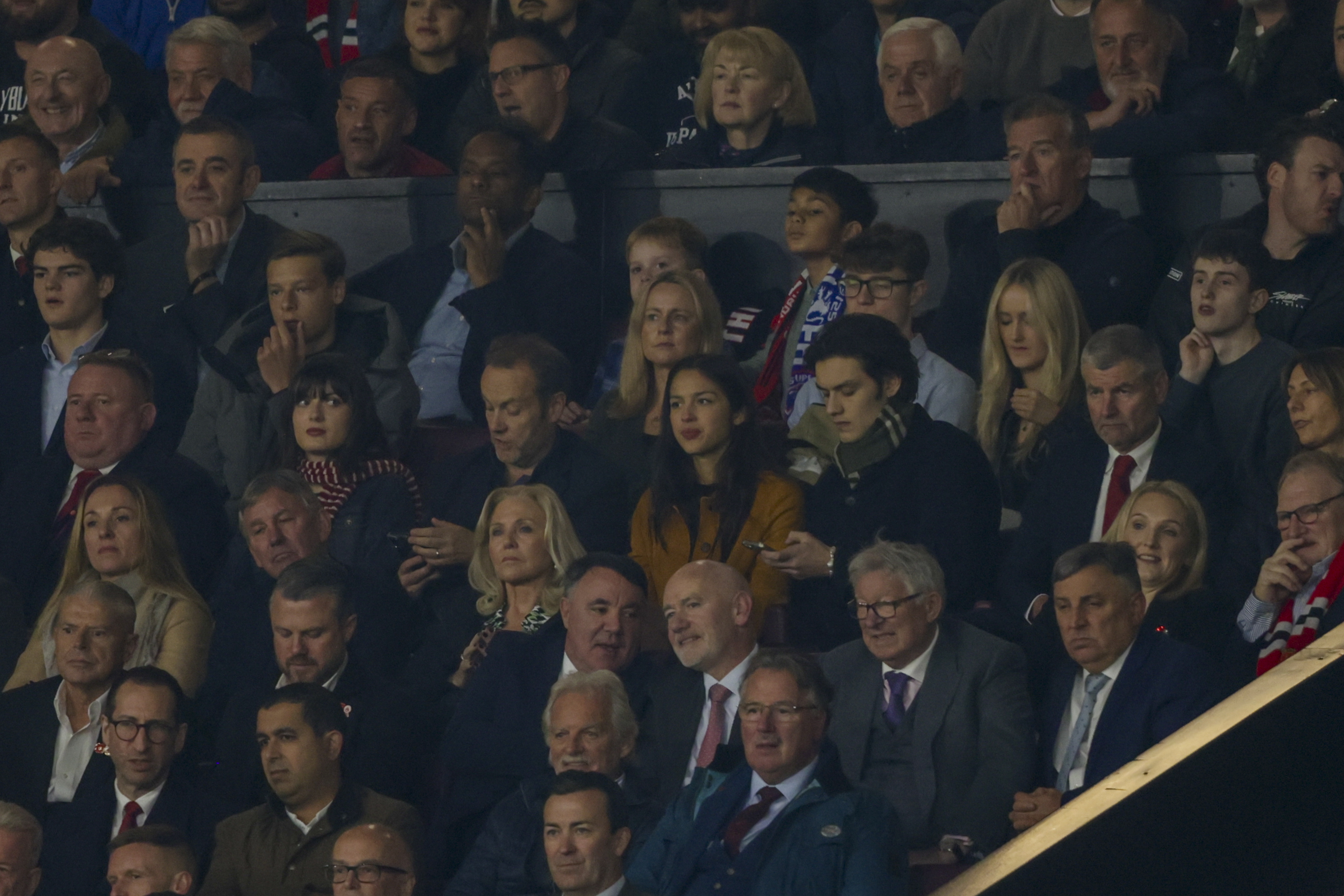 American singer-songwriter and actress Olivia Rodrigo, centre, attends the Premier League soccer match between Manchester United and Chelsea at Old Trafford stadium in Manchester, England, Sunday, Nov. 3, 2024. (AP Photo/Ian Hodgson)