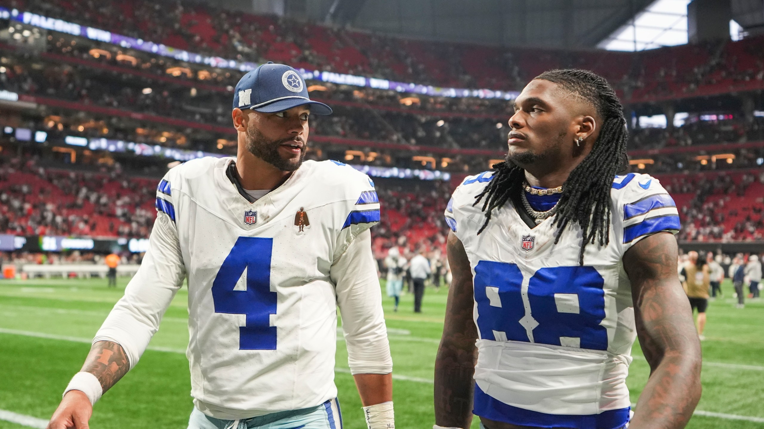 Dallas Cowboys quarterback Dak Prescott (4) walks off the field with wide receiver CeeDee Lamb (88) after an NFL football game against the Atlanta Falcons, Sunday, Nov. 3, 2024, in Atlanta. The Falcons won 27-21. (AP Photo/ Brynn Anderson)