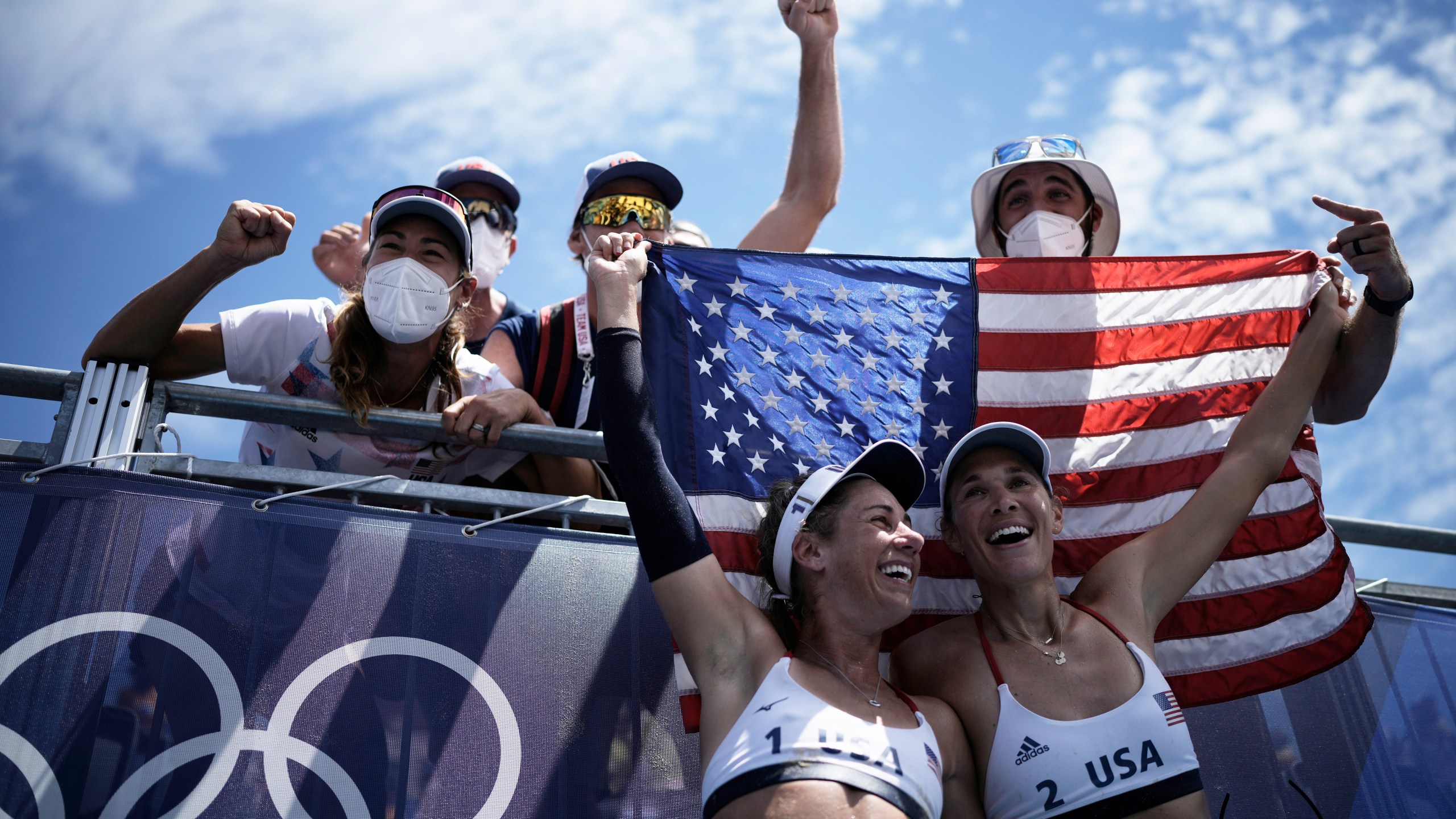 FILE - April Ross, bottom left, of the United States, and teammate Alix Klineman, bottom right, celebrate after winning a women's beach volleyball gold medal match against Australia at the 2020 Summer Olympics, Aug. 6, 2021, in Tokyo, Japan. (AP Photo/Felipe Dana, File)