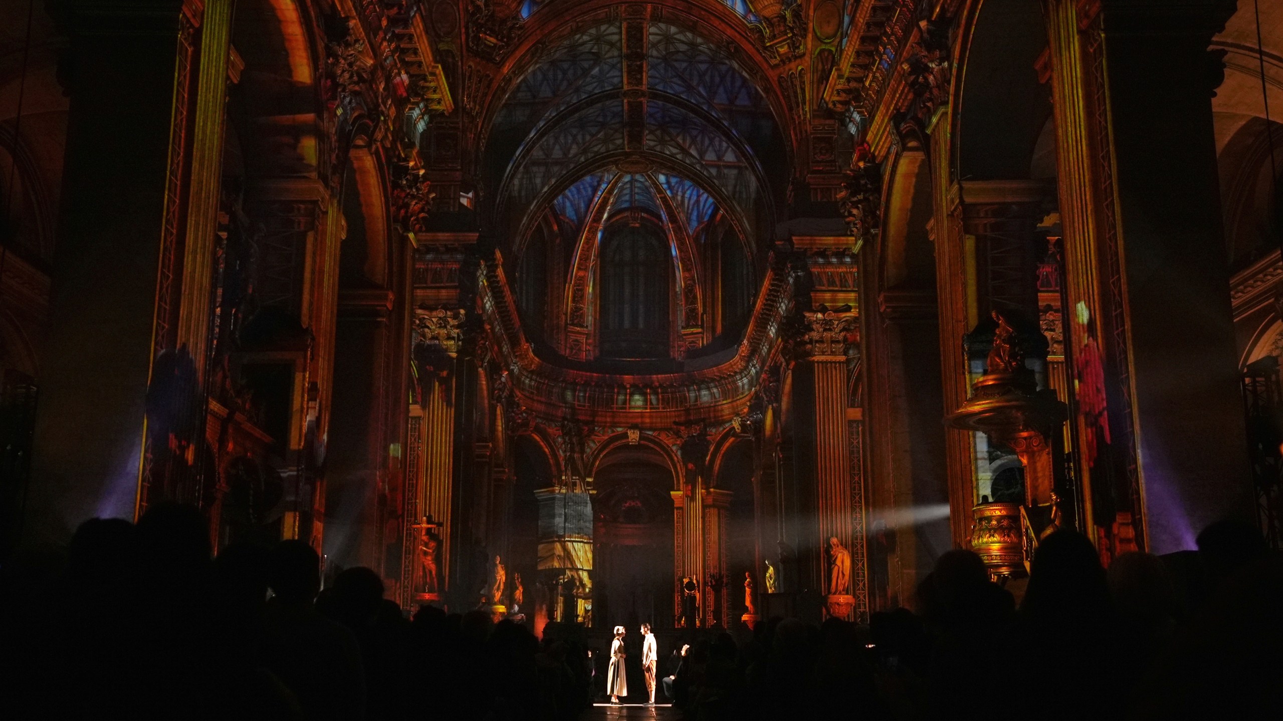 Actors and video projections are seen Thursday Oct.31, 2024 at the Saint-Sulpice church in Paris. (AP Photo/Marine Lesprit)