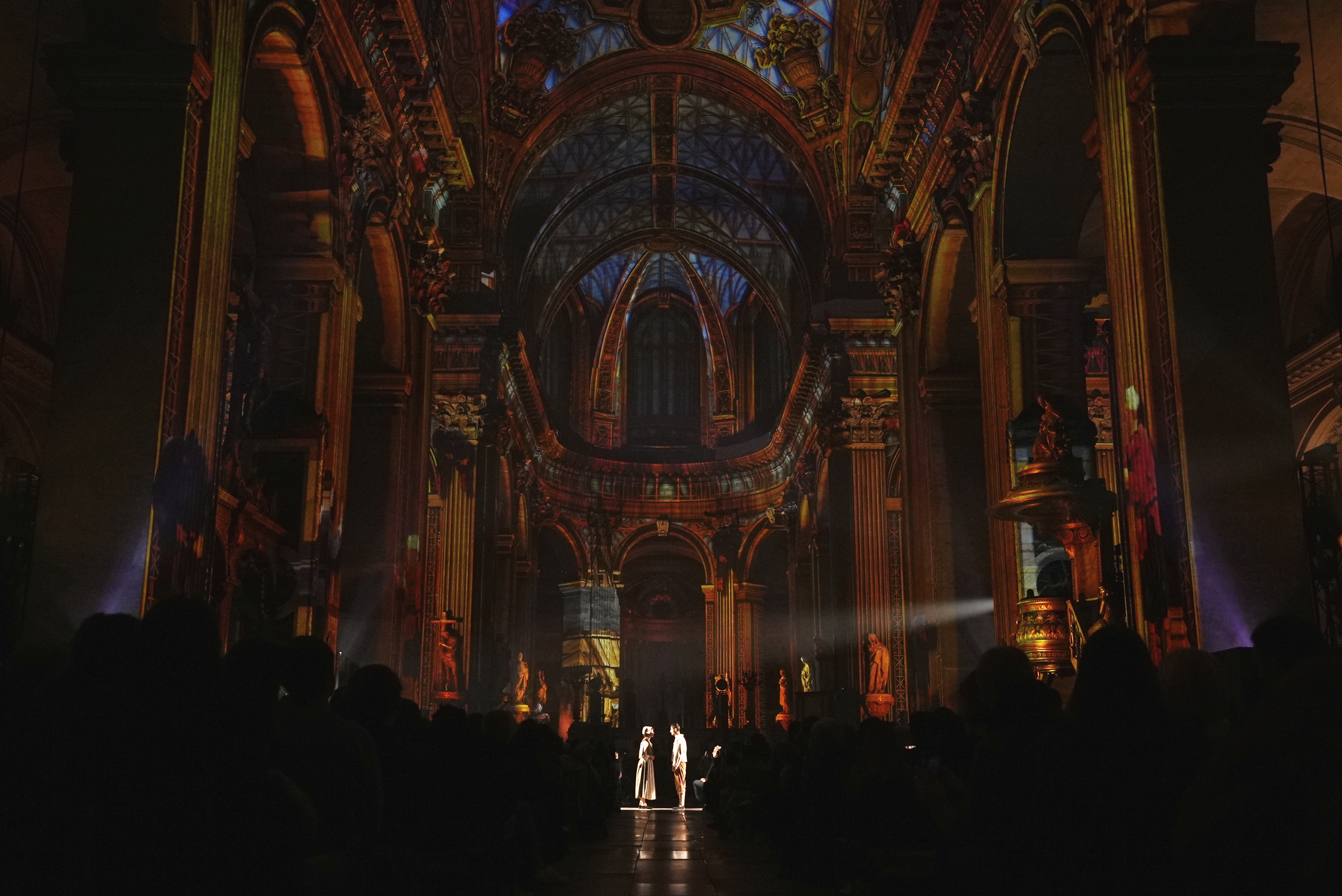 Actors and video projections are seen Thursday Oct.31, 2024 at the Saint-Sulpice church in Paris. (AP Photo/Marine Lesprit)