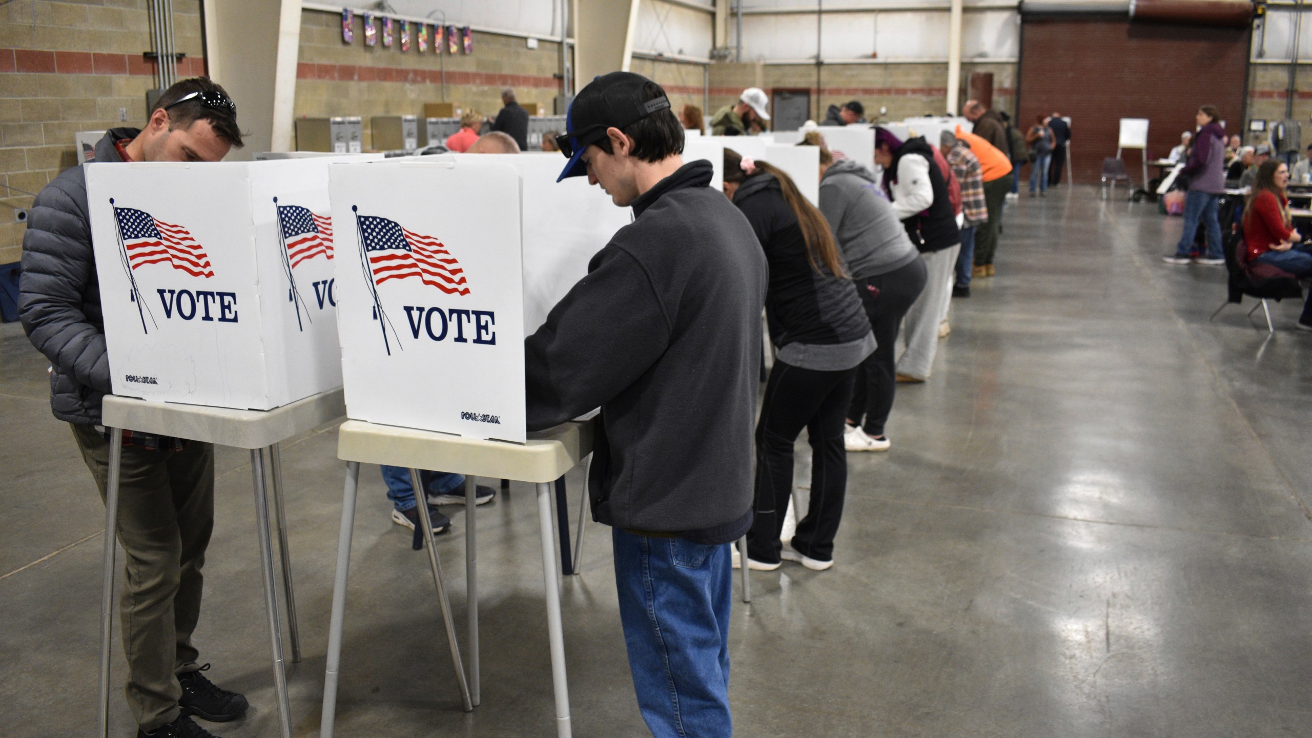 People fill out ballots during Election Day at MetraPark, Nov. 5, 2024, in Billings, Mont. (AP Photo/Matthew Brown)