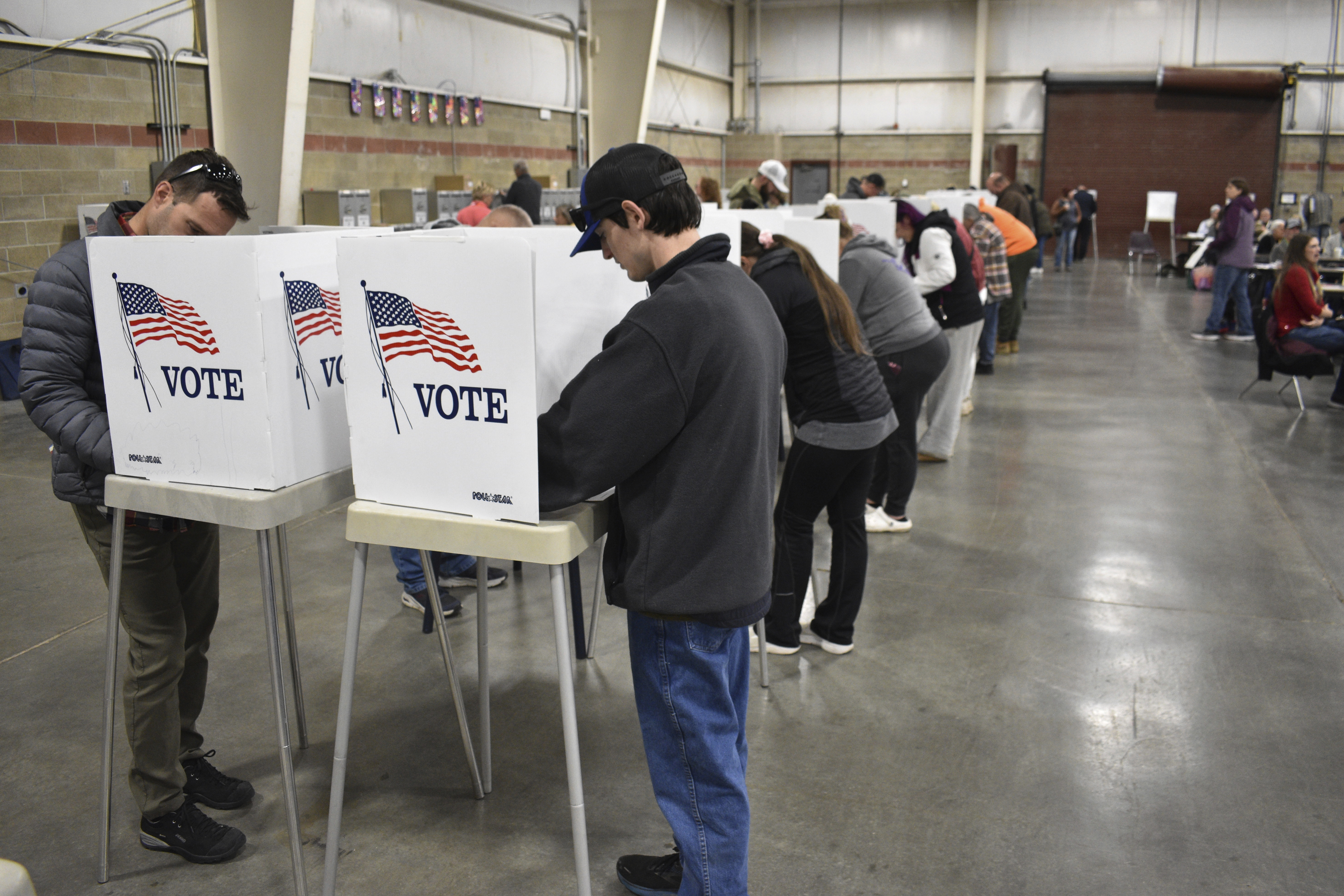 People fill out ballots during Election Day at MetraPark, Nov. 5, 2024, in Billings, Mont. (AP Photo/Matthew Brown)