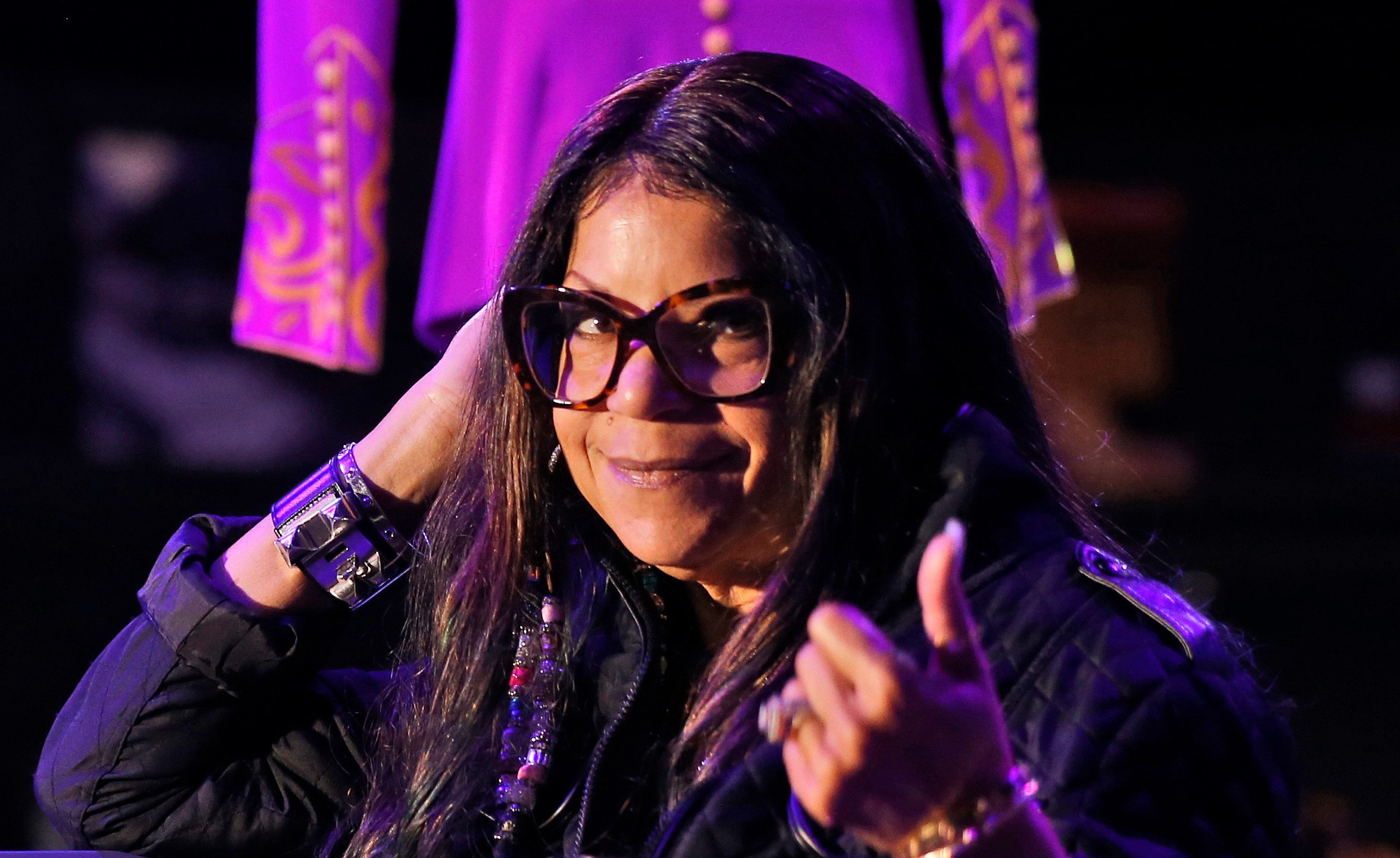 FILE - Tyka Nelson, sister of the late musician Prince, appears in front of his costumes at the "My Name is Prince" exhibition at the O2 Arena in London, on Oct. 26, 2017. (AP Photo/Frank Augstein, File)