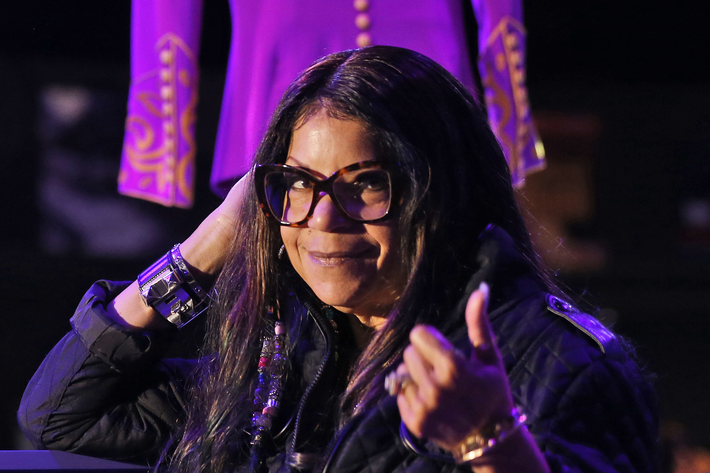 FILE - Tyka Nelson, sister of the late musician Prince, appears in front of his costumes at the "My Name is Prince" exhibition at the O2 Arena in London, on Oct. 26, 2017. (AP Photo/Frank Augstein, File)