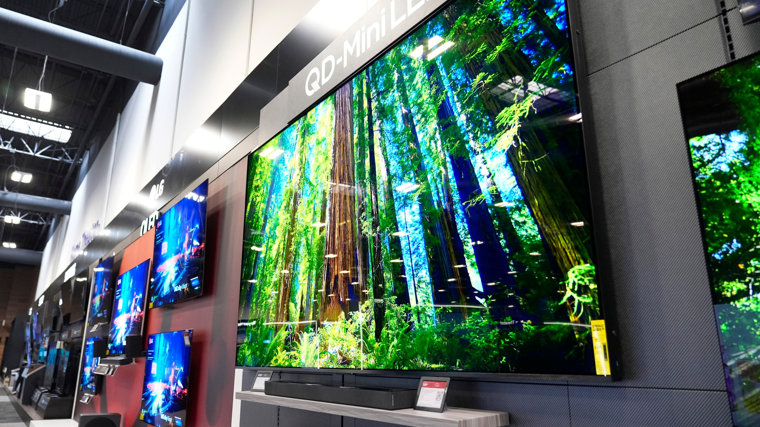 A 115-inch TCL television, right, is displayed at a Best Buy store in Dallas, Friday, Oct. 25, 2024. (AP Photo/Tony Gutierrez)