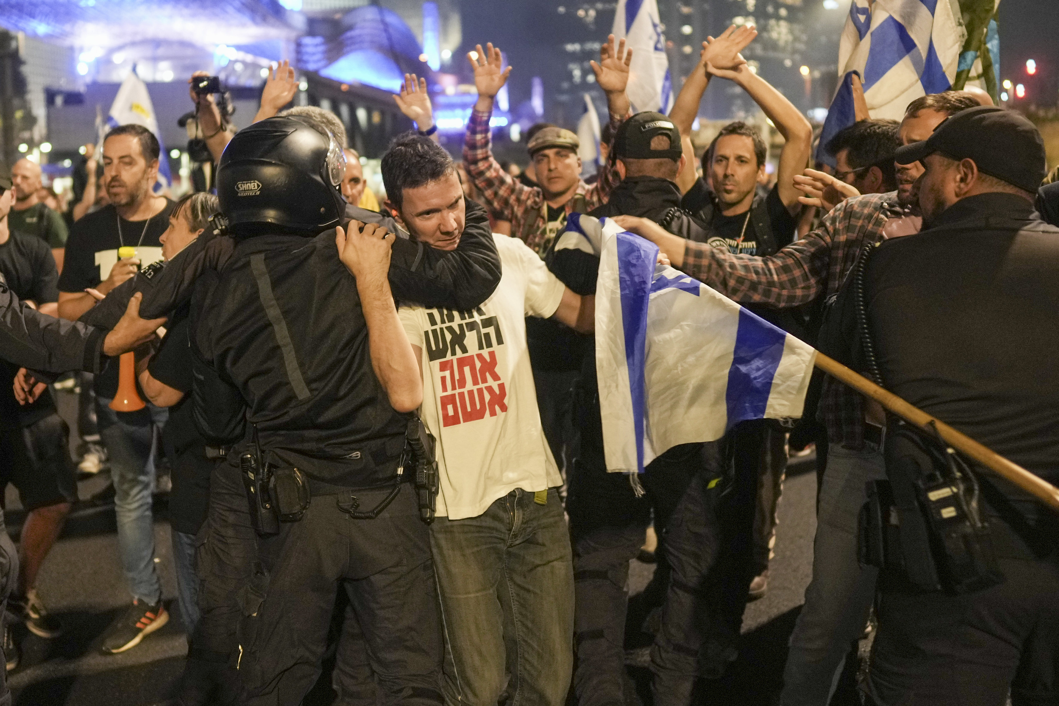 Israeli police try to push back protesters from a main road after Prime Minister Benjamin Netanyahu has dismissed his defense minister Yoav Gallant in a surprise announcement in Tel Aviv, Israel, Tuesday, Nov. 5, 2024. (AP Photo/Oded Balilty)