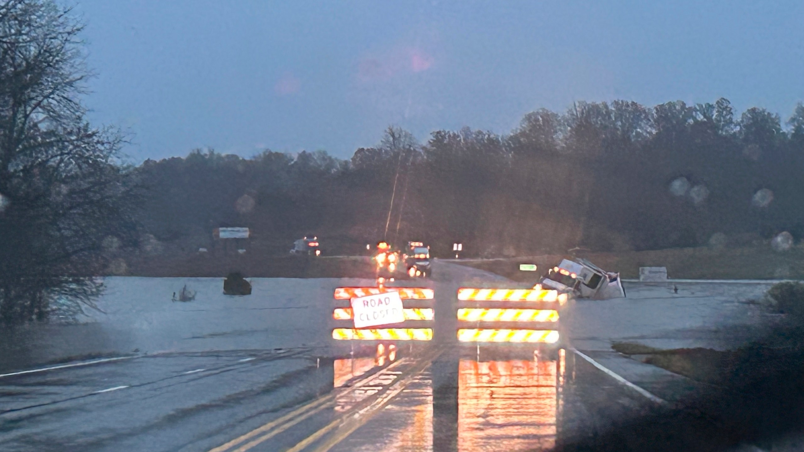 In a photo released by the Missouri State Highway Patrol, a tractor trailer sits submerged in flood water on US 63 just north of Cabool, Mo., Tuesday, Nov. 5, 2024. (Missouri State Highway Patrol via AP)