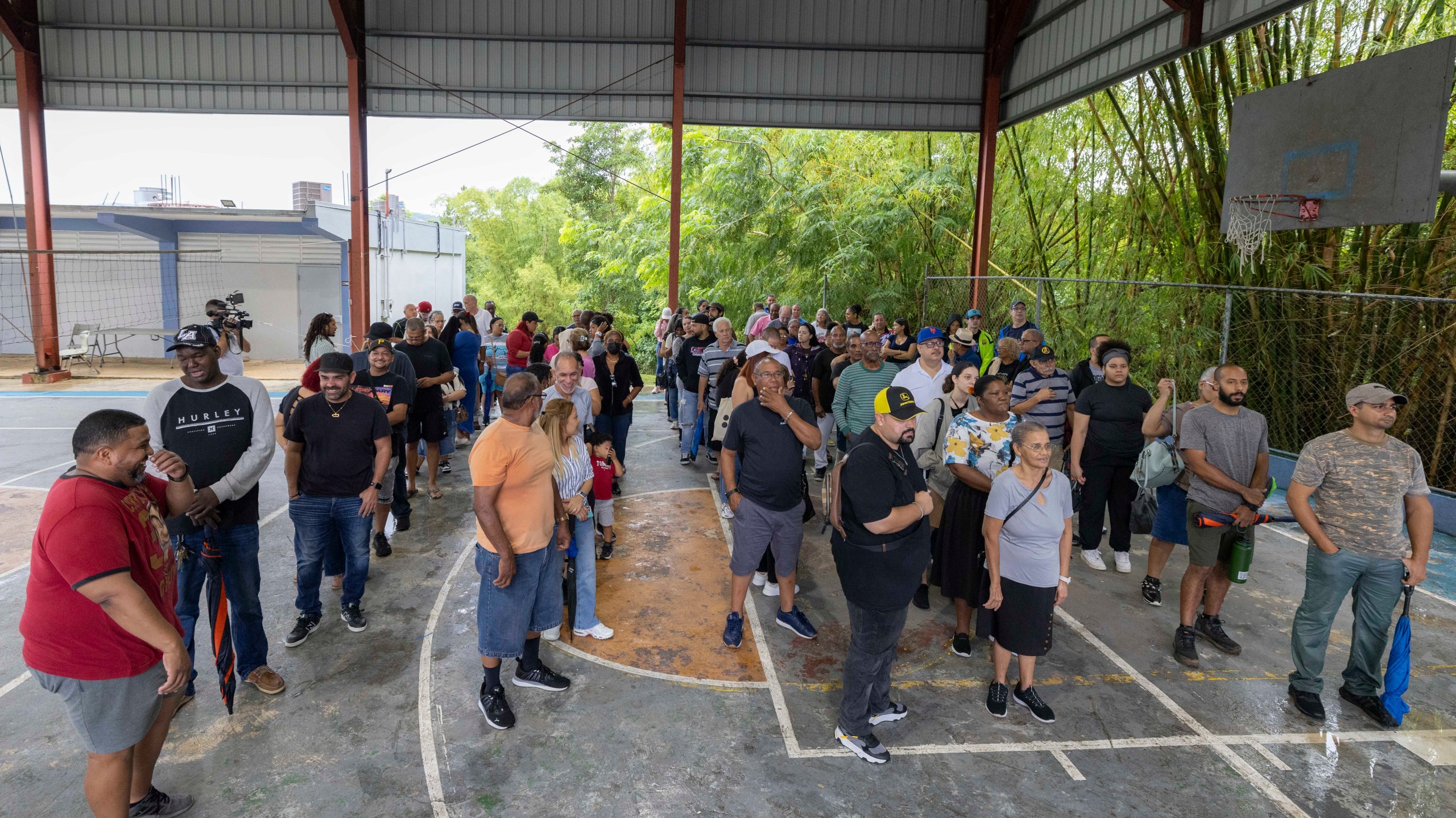 Voters line up at a polling station during general elections in San Juan, Puerto Rico, Tuesday, Nov. 5, 2024. (AP Photo/Alejandro Granadillo)