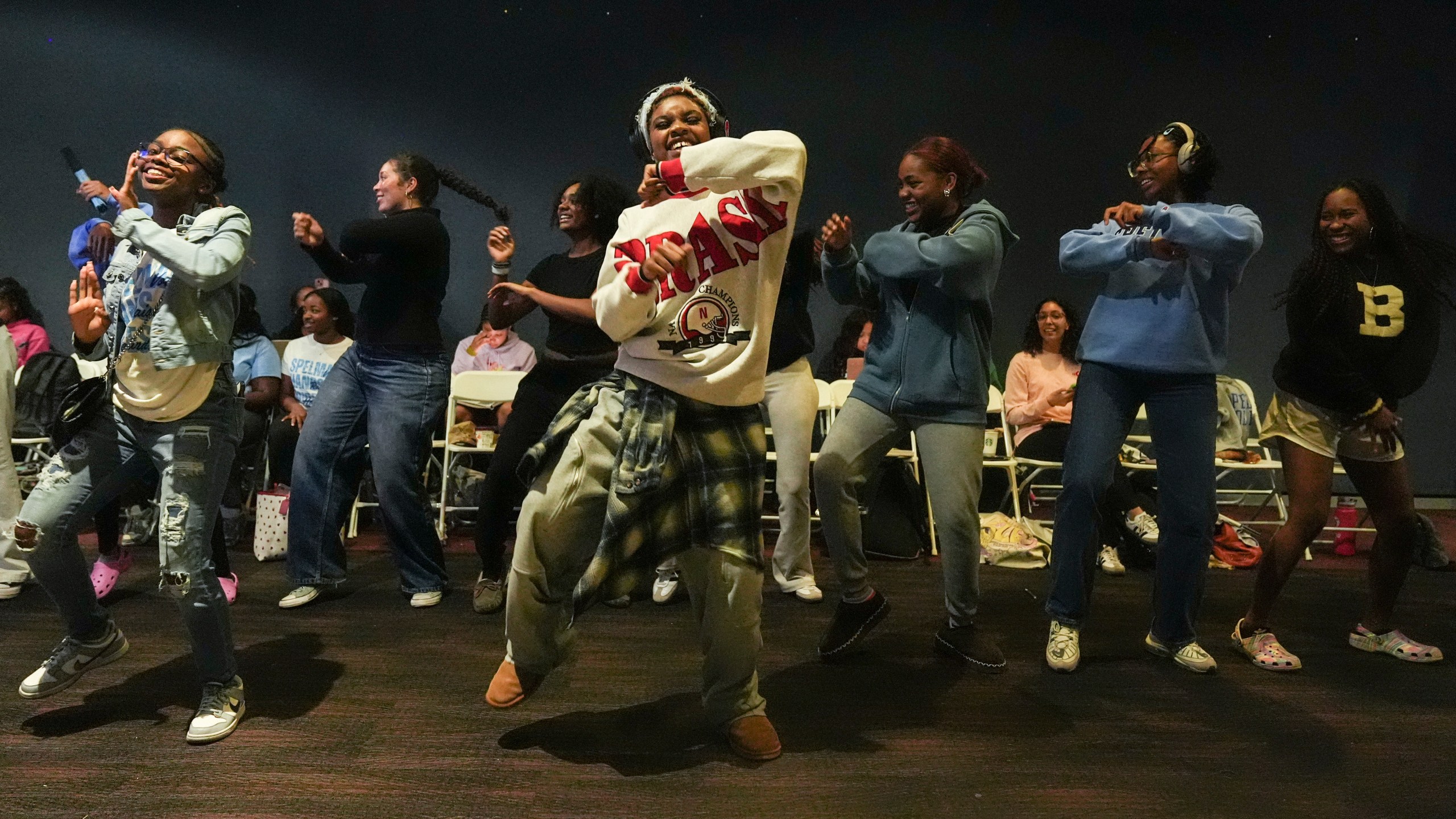 Students dance as they watch election coverage at Spelman College, Tuesday, Nov. 5, 2024, in Atlanta. (AP Photo/Brynn Anderson)