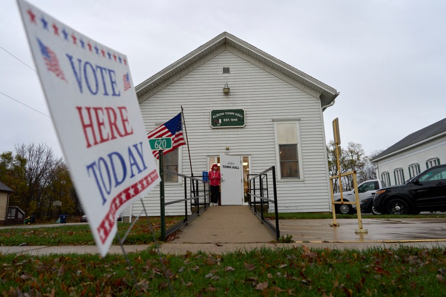 A voter leaves Albion Town hall after casting their ballot on Election Day, Tuesday, Nov. 5, 2024, in Albion, Wis. (AP Photo/Kayla Wolf)