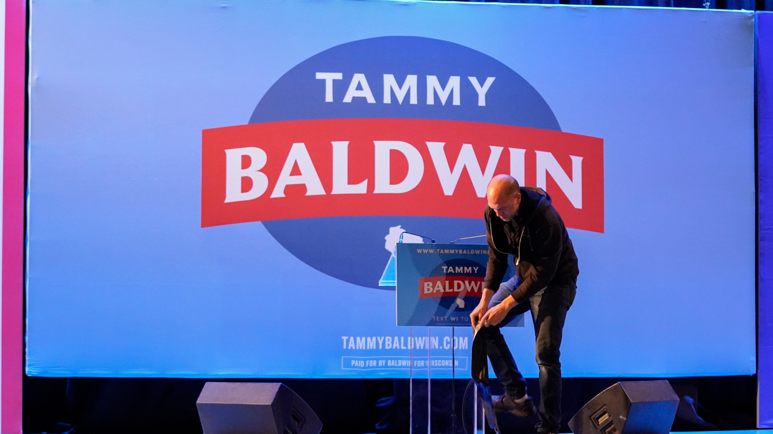 An employee breaks down items on a stage after an election night watch party for Sen. Tammy Baldwin, D-Wis., Wednesday, Nov. 6, 2024, in Madison, Wis. (AP Photo/Kayla Wolf)